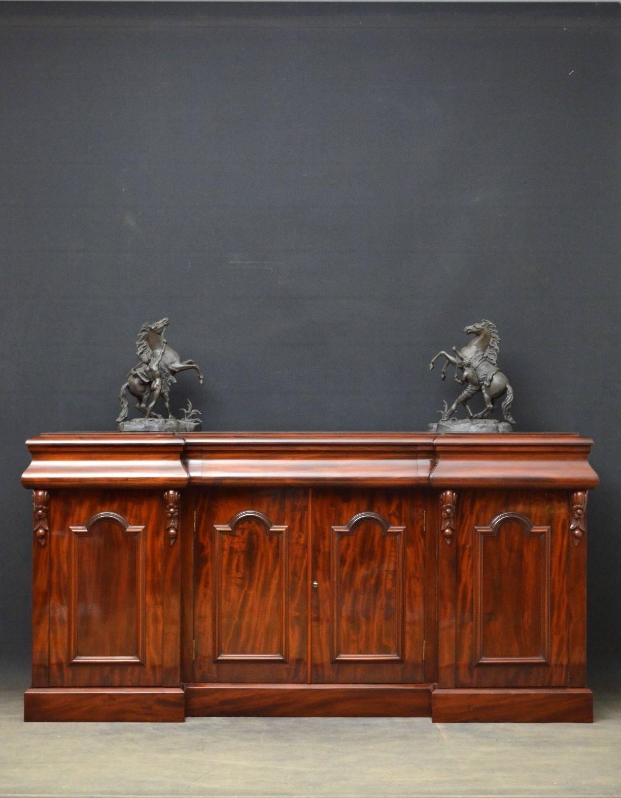 Sn4025 a quality, Victorian, mahogany sideboard, having figured top, three shaped frieze drawers above a pair of flamed mahogany arched and panelled cupboard doors enclosing shelf flanked by further arched and panelled cupboard doors with fine drop