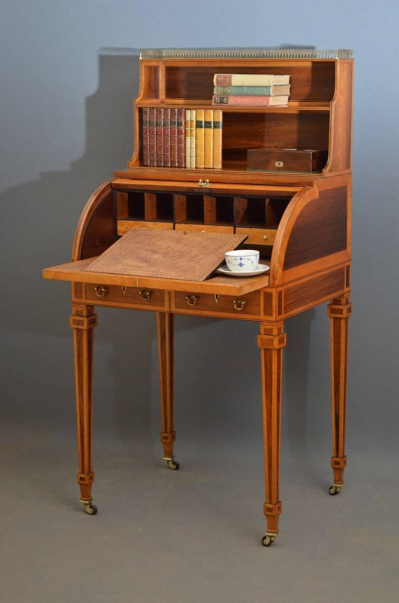 Sn3169, exceptional Sheraton Revival, Edwardian rosewood bureau, writing table, having original pierced, brass gallery above two waterfall shelves, batwing inlaid cylinder fall which opens to reveal pigeon holes, small drawers and adjustable tooled