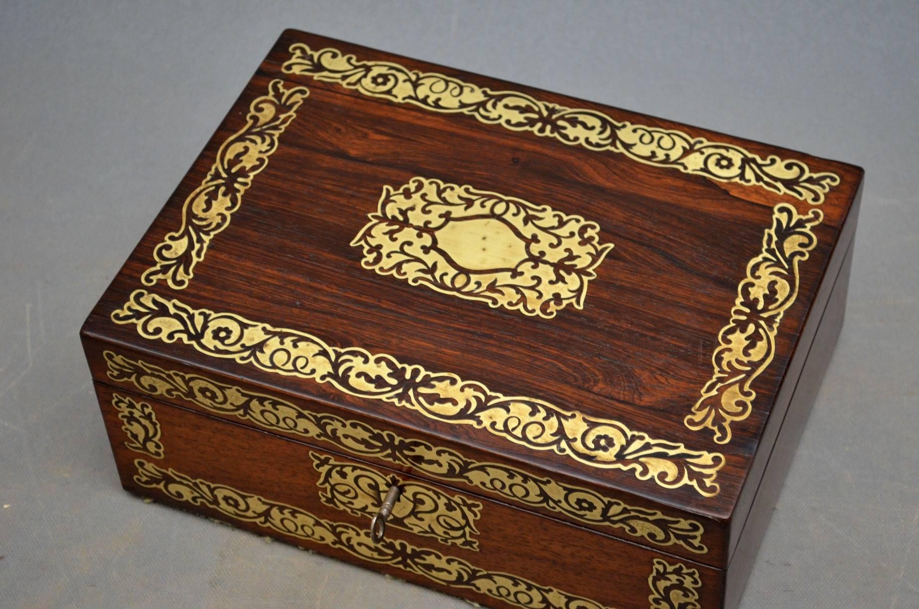 K0192. A stunning Regency rosewood jewelry box/sewing box, having brass decorated front and hinged top which opens to reveal immaculate blue interior with lift up tray, all fitted with original working lock an key. This is a truly exceptional box in