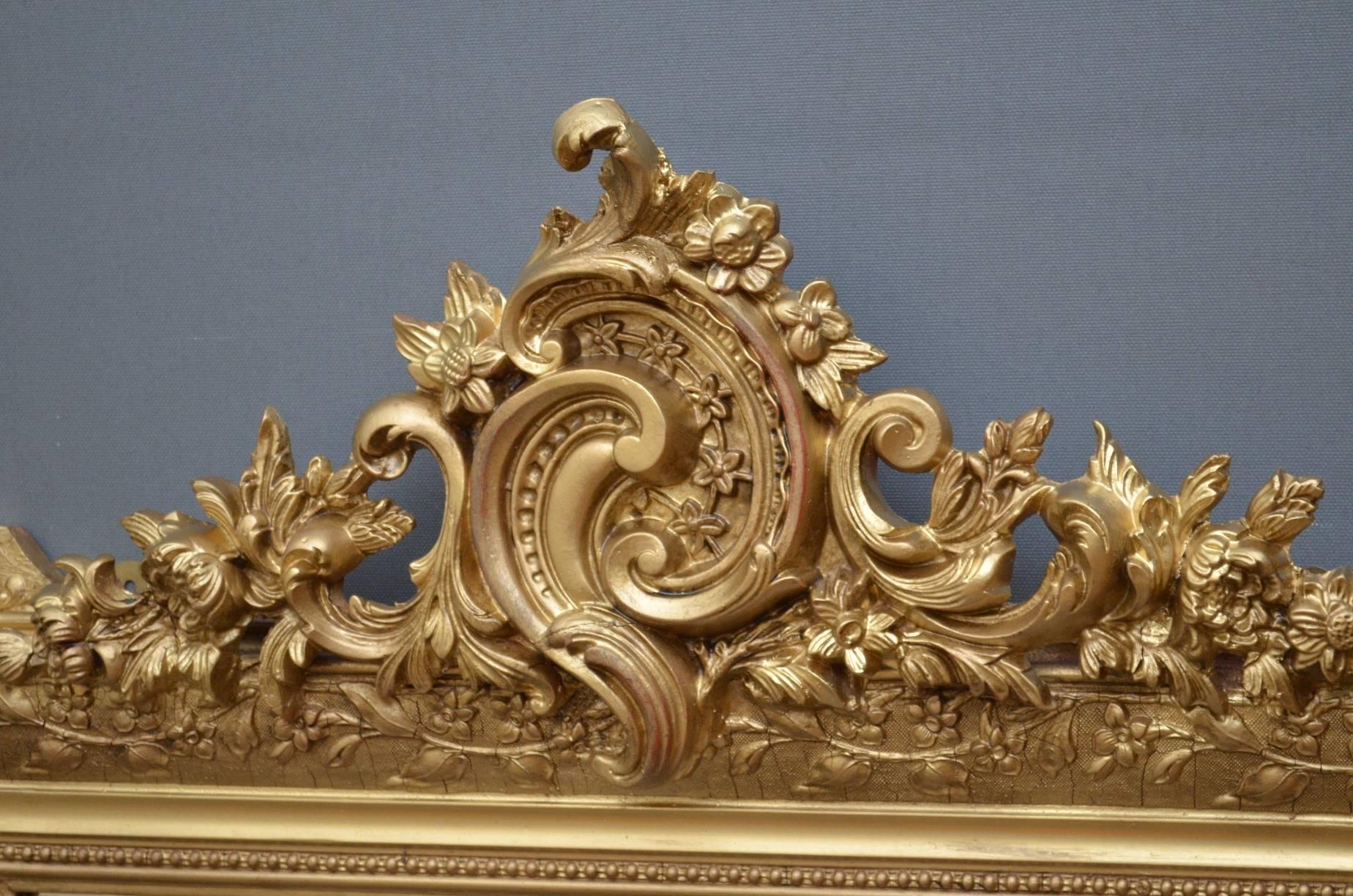 K0119 stylish and very elegant, 19th century, giltwood wall mirror of small proportions, having exceptional cresting with scrolls, flowers and leaves to top, and original mirror plate in finely carved frame. This attractive overmantel has been
