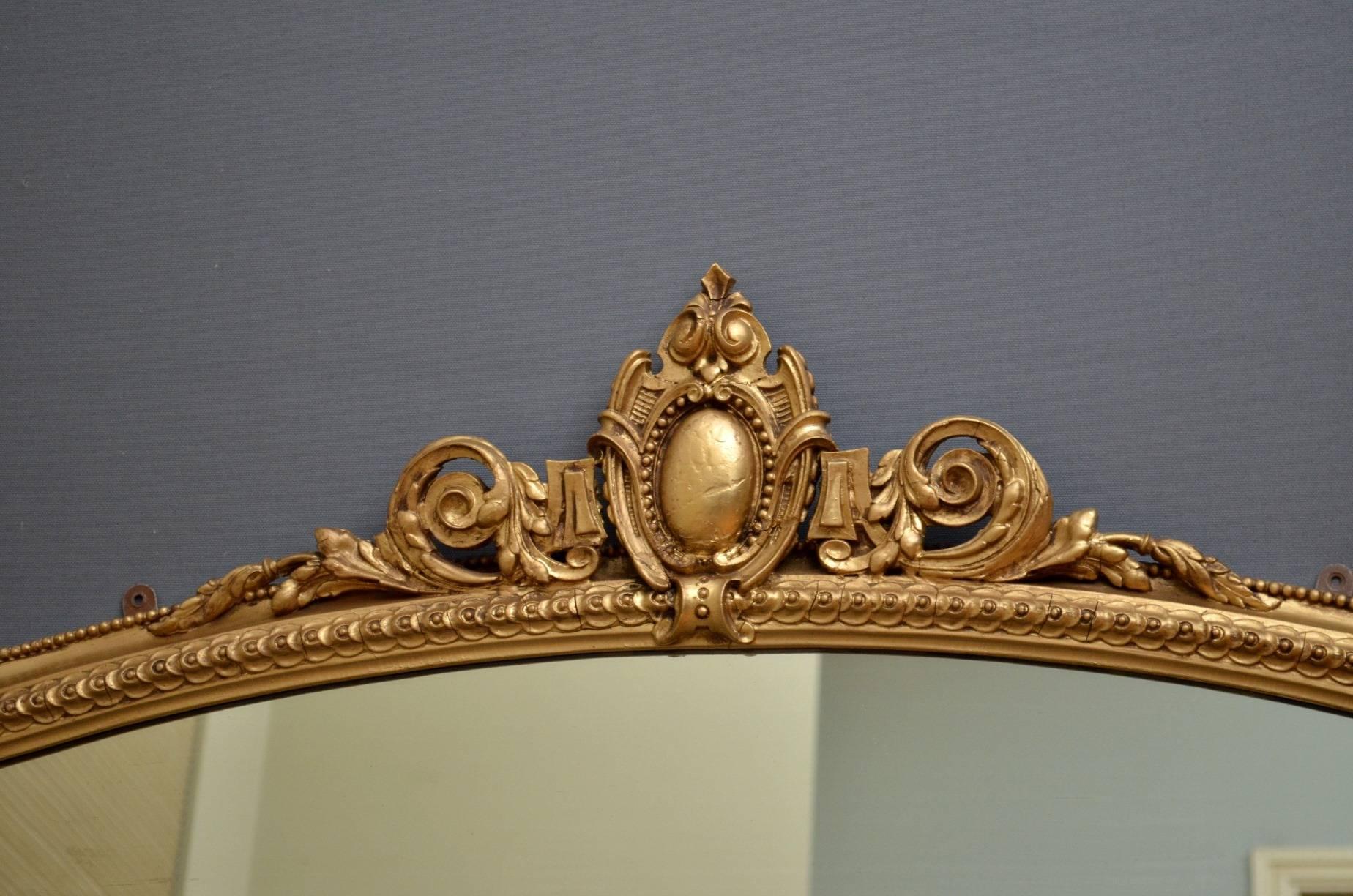 K0217, an elegant Victorian gilt mirror with cartouche shaped cresting to centre, beaded and carved border with Fine scrolls and original mirror plate with some foxing and marks commensurate with age. This attractive mirror has been refinished and