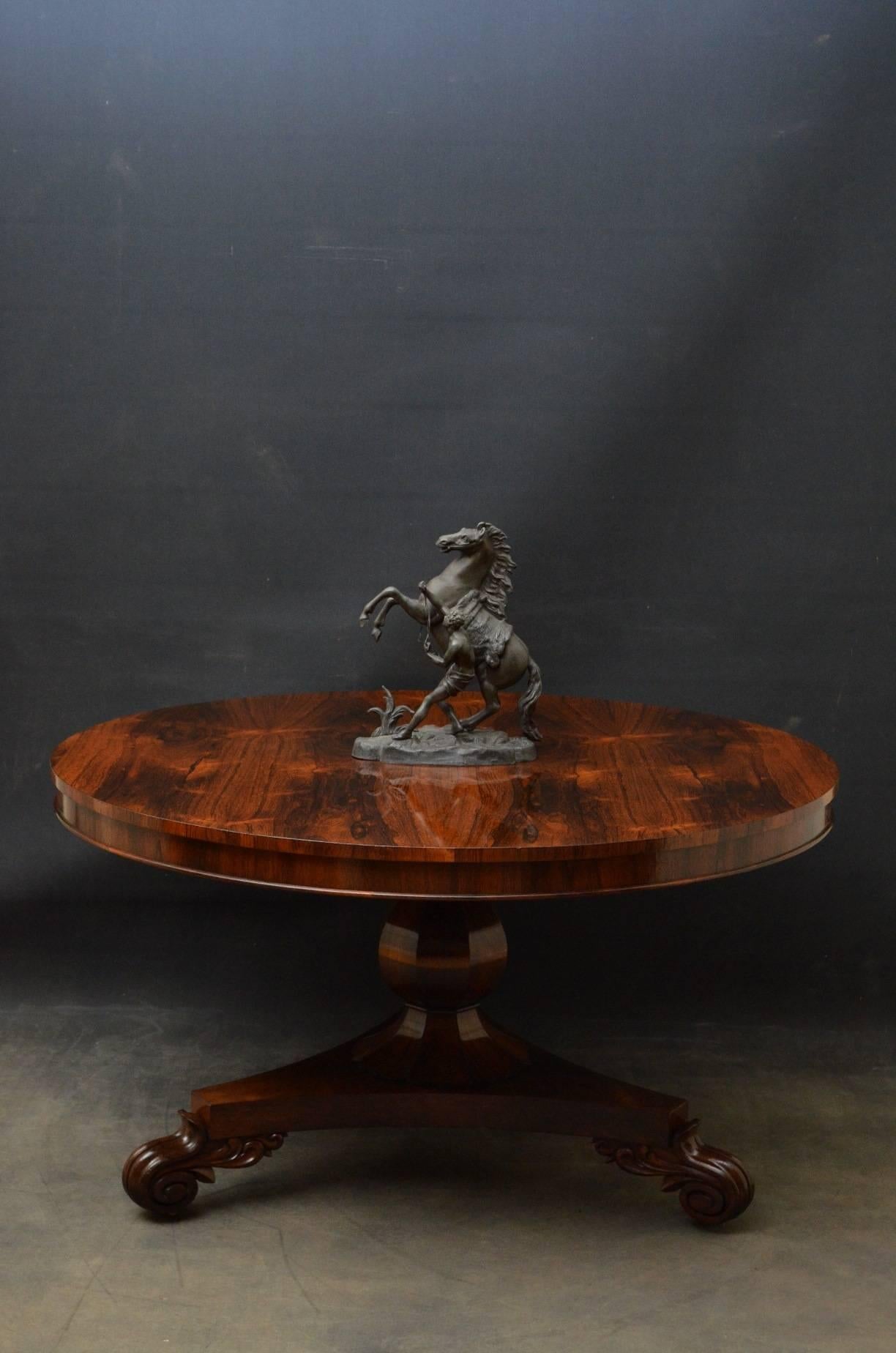 Sn3690 stunning William IV tilt-top dining table or centre table in rosewood, having stunning top raised on flat faceted vase shaped column with carved collar terminating in trefoil base, carved scroll feet and castors. This is an exceptional dining