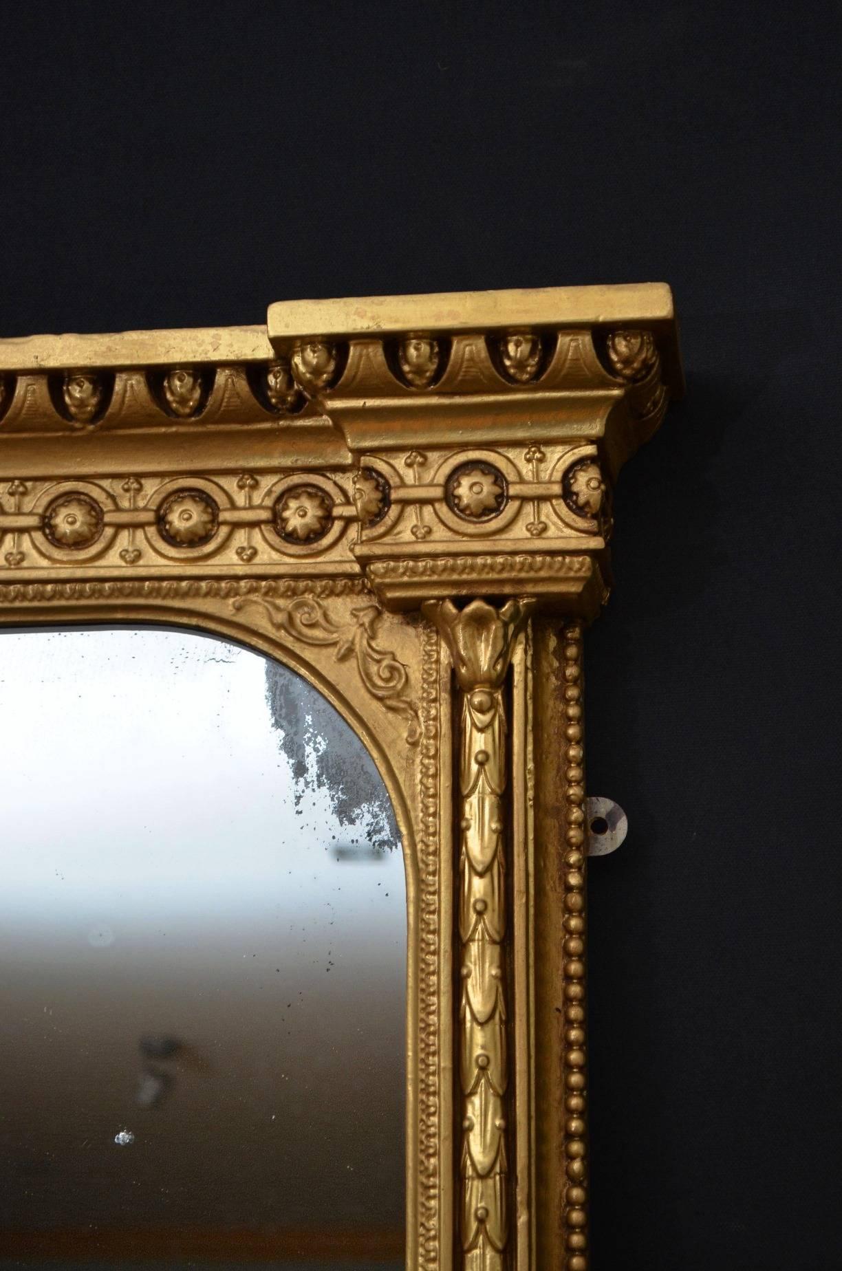 K0219, very impressive English gilt wall mirror of large proportions, having original mirror plate with foxing and age related marks in beautifully decorated giltwood frame. The frame has been refinished in the past and it is wonderful condition