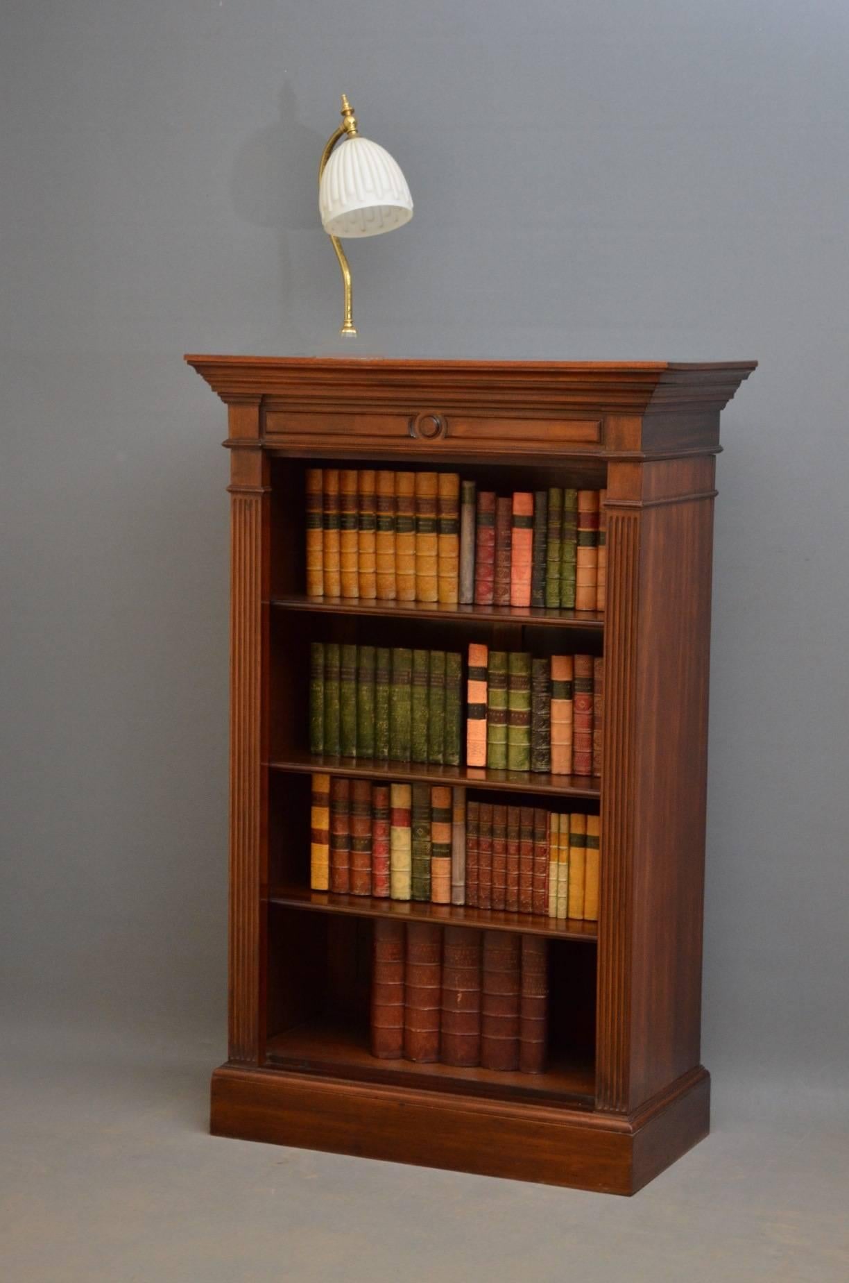 Sn3450, Victorian mahogany open bookcase of slim design, having moulded top above moulded frieze and three height adjustable shelves flanked by reeded pilasters, all standing on moulded plinth base. This antique bookcase or bookshelves is in