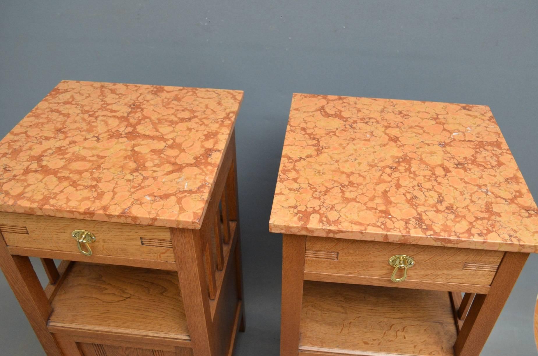 Sn4081, a pair of Continental bedside cabinets in oak and , each having marble top above oak lined drawer and panelled cupboard door below, all fitted with original brass handles. This pair of bedside cabinets is in excellent condition throughout,