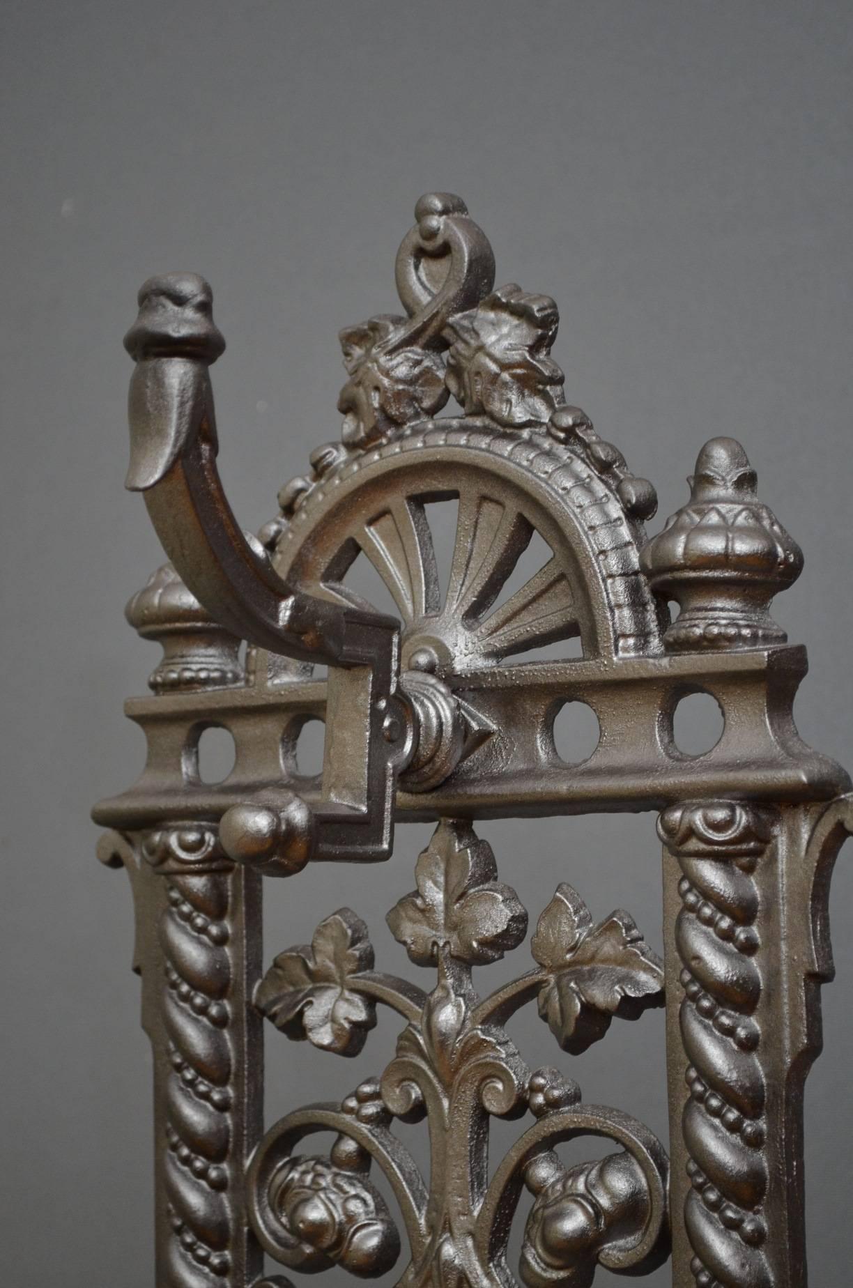 K0224, truly excellent and very decorative, Victorian cast iron hall stand, having, arched mirror to back and five coat hooks over umbrella holder all with fruit and floral decoration throughout. This cast iron coat stand is in excellent condition,