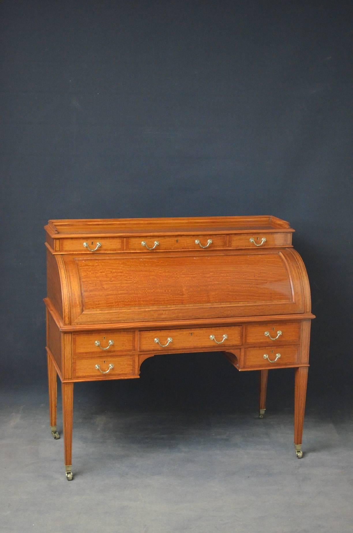 Sn4097 Superb quality and very attractive, late Victorian satinwood cylinder bureau by Maples & Co, having fine gallery to top and three mahogany lined drawers fitted with original brass handles above cylinder front which open to reveal small