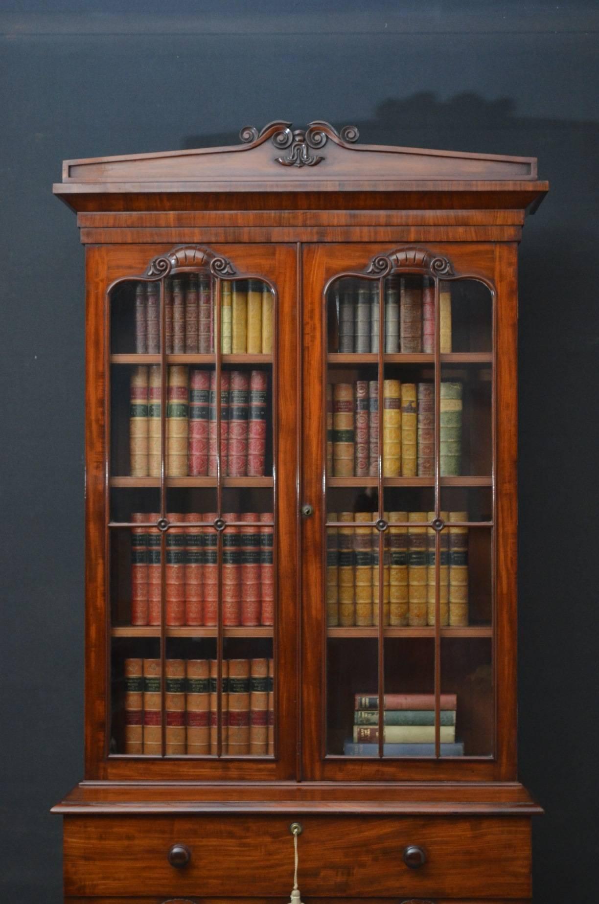 Sn4112 fine quality William IV mahogany bookcase of narrow proportions, having architectural pediment above a pair of glazed doors enclosing 3 height adjustable shelves and fitted with working lock and a key, the base having mahogany lined drawer