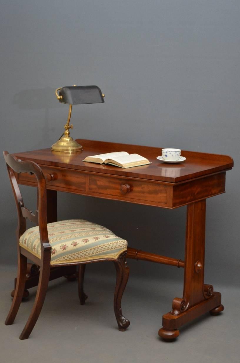Sn3125, exceptional William IV, mahogany side table or writing table, having shaped upstand fabulous figured top with two frieze drawers, raised on shaped and scrolled supports terminating in bun feet, all united by tulip carved stretcher. This is a