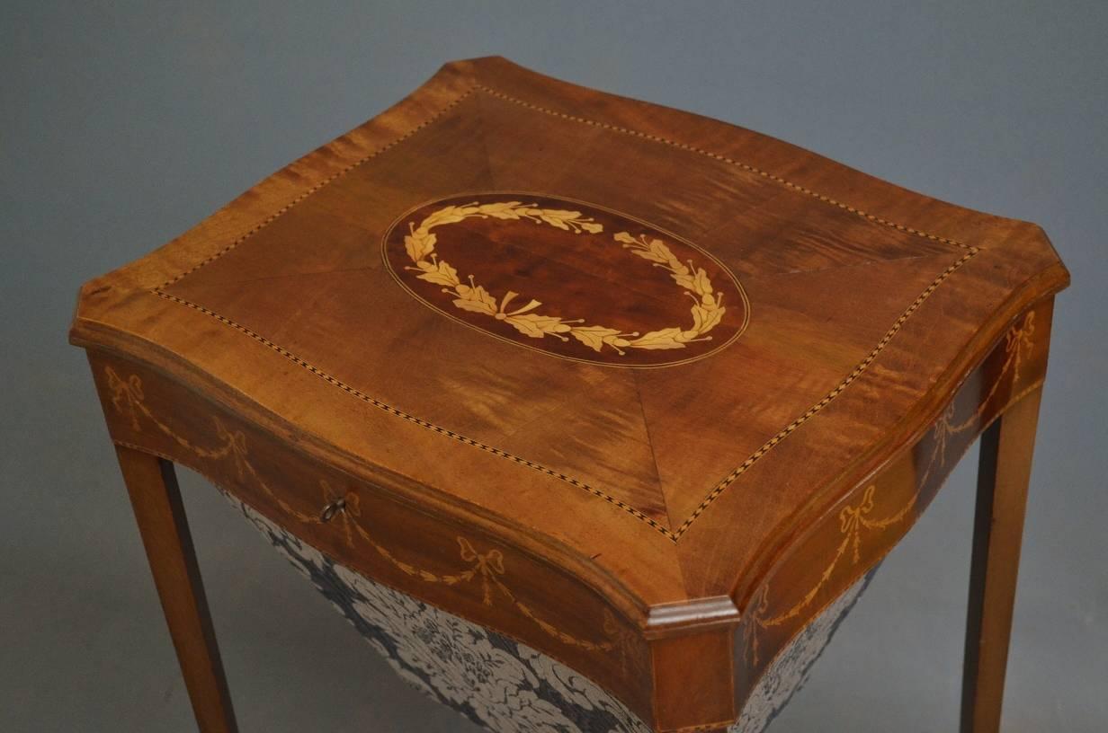 Sn3131 attractive Edwardian, mahogany and inlaid sewing / work table, having finely inlaid, serpentine, hinged top, which opens to reveal fitted interior and ribbon and harebells inlaid frieze, all raise on elegant satinwood inlaid legs united by