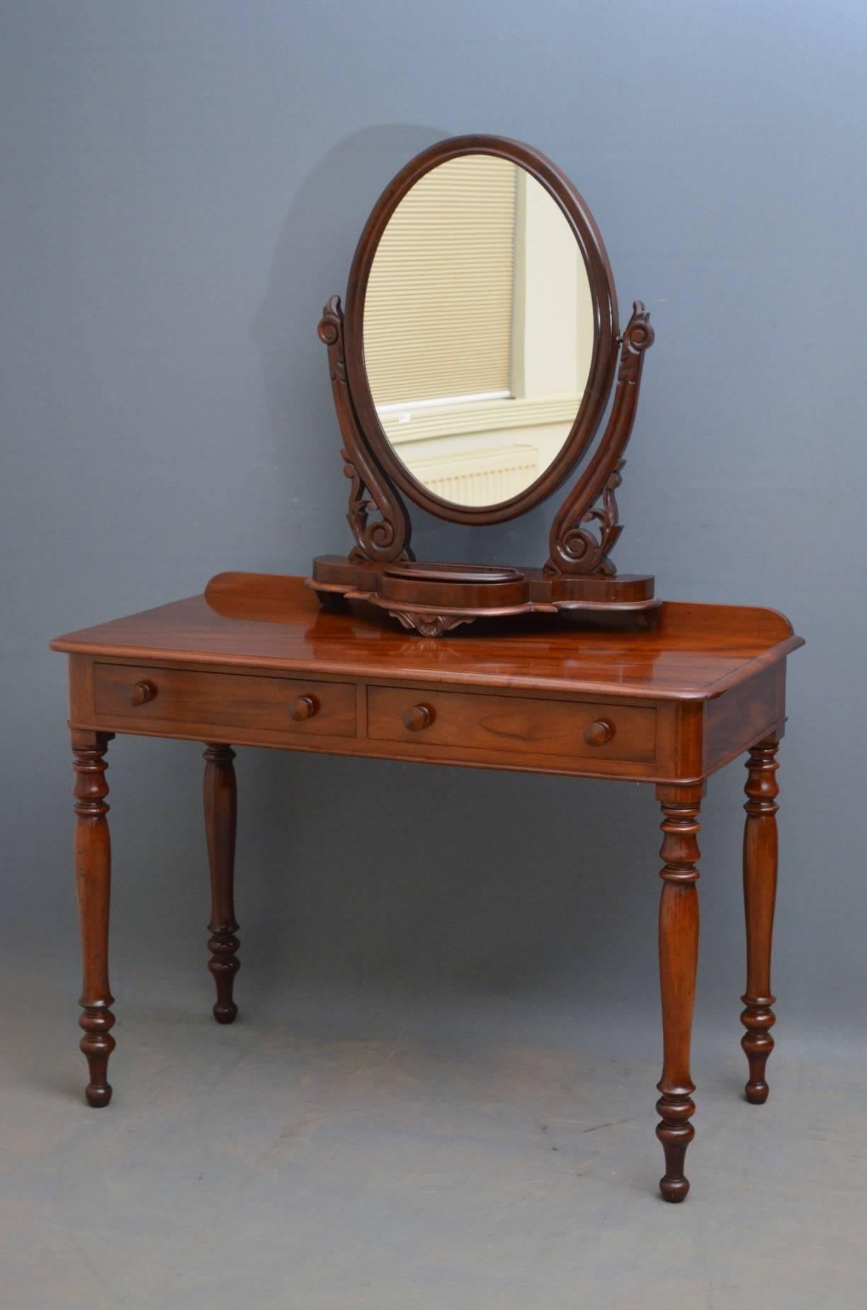 Sn3654 Victorian mahogany side table with up stand to back, figured mahogany moulded top and two frieze drawers fitted with original turned knobs, standing on turned legs. This Victorian table would make a good dressing or writing table. Mirror not
