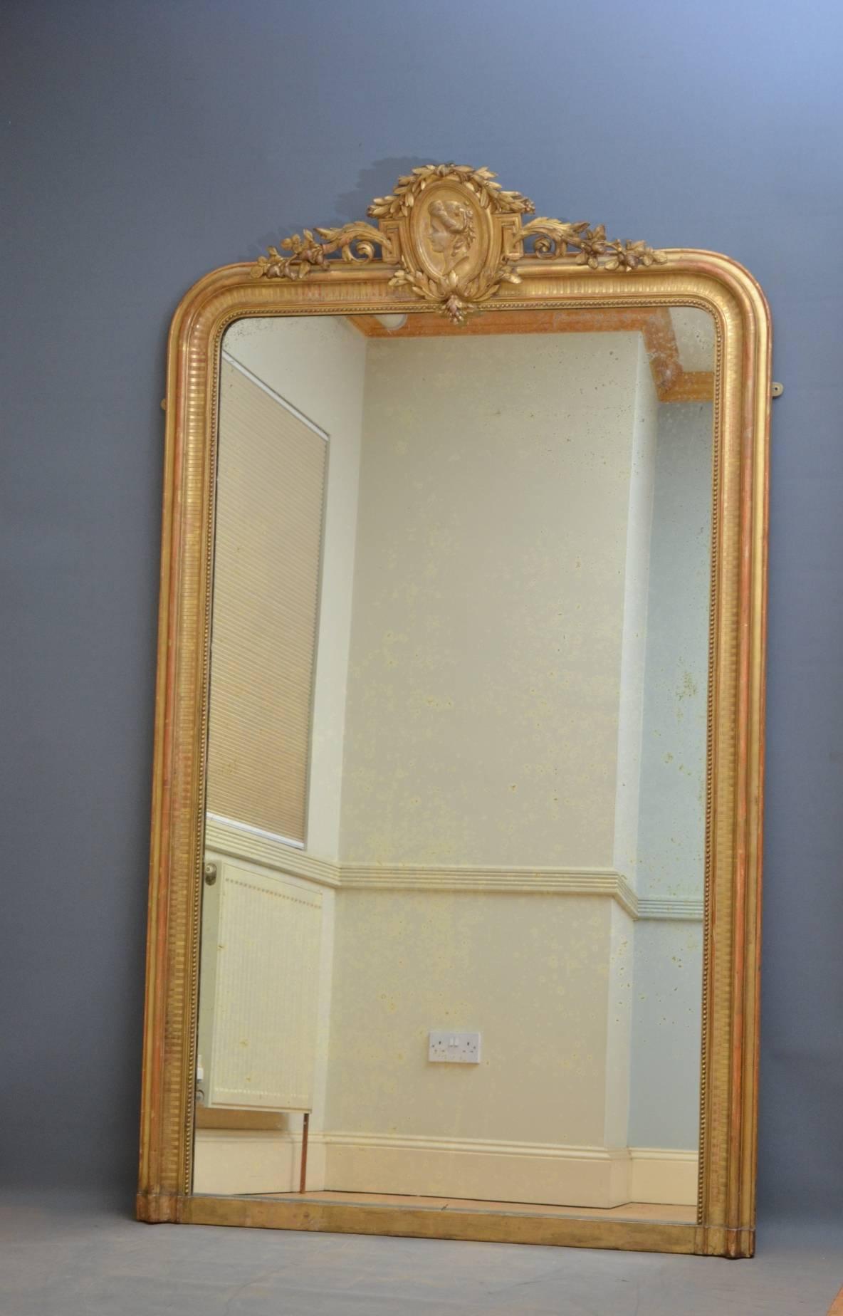 K0248 large French gilt mirror, having fine cartouche with floral motifs to centre and original mirror plate in beaded and moulded frame. This mirror retains its original gilt and mirror plate with fantastic foxing throughout. The mirror can floor