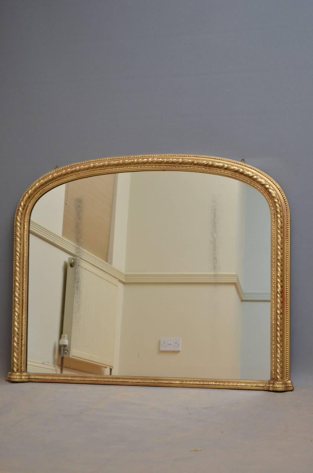 K0244 Victorian gilt overmantel of arched form with original mirror plate in twisted rope decorated and beaded frame. This mirror has been refinished and is in wonderful condition throughout, ready to place at home. This mirror bears maker's label