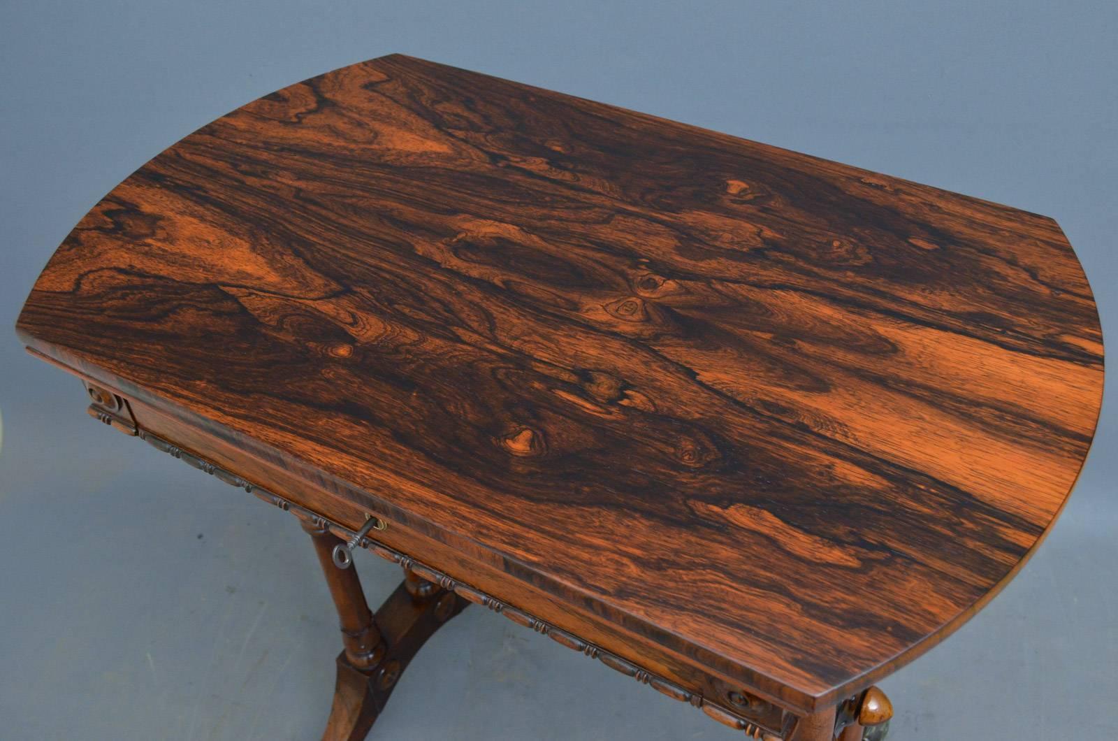 Sn4221 a Regency lamp table in rosewood, having shaped top above frieze drawers and turned and carved supports terminating in down swept legs and original brass castors. This antique table retains its original finish with some repolishing to the