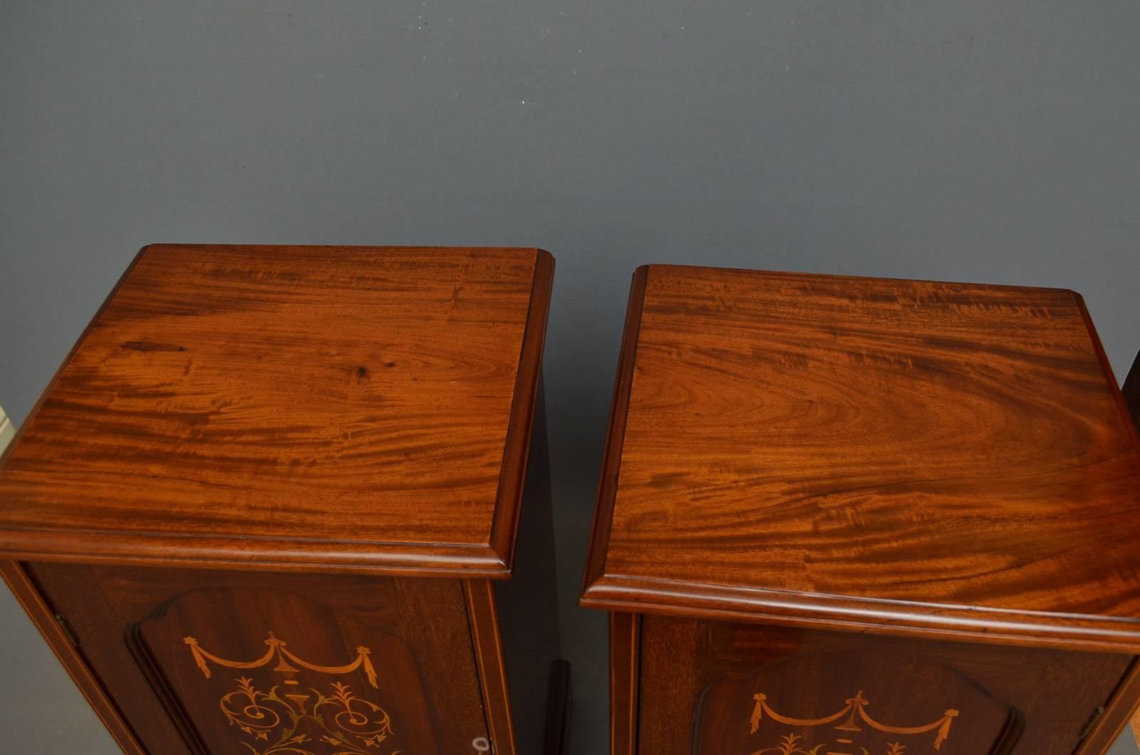 Sn4163, pair of Edwardian mahogany bedside cabinets each having moulded top above a panelled door fitted with working lock and key and enclosing a shelf, all standing on plinth base. This antique pair of bedside cabinets is ready to place at home.
