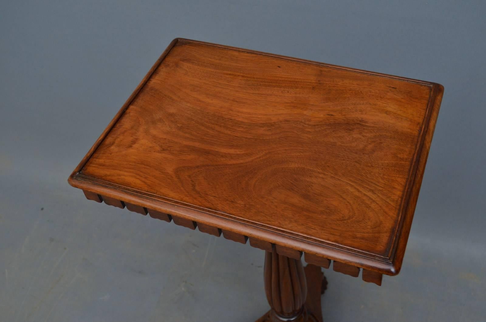 K0254 A Regency mahogany occasional table, having figured top above carved frieze and fluted and carved column terminating in trefoil base and reeded bun feet. This Regency table retains its original finish which has been cleaned, revived and waxed.