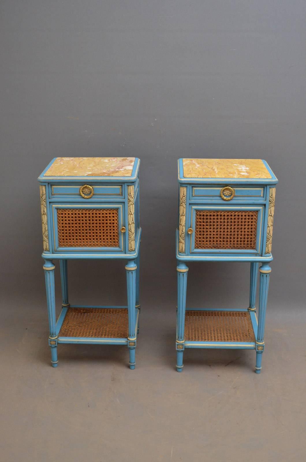 Sn4228 pair of 19th century painted bedside cabinets, each having original marble top above a drawer and a cupboard door with cane work to front, all fitted with original brass handles, standing on turned and reeded legs united by caned shelf. This