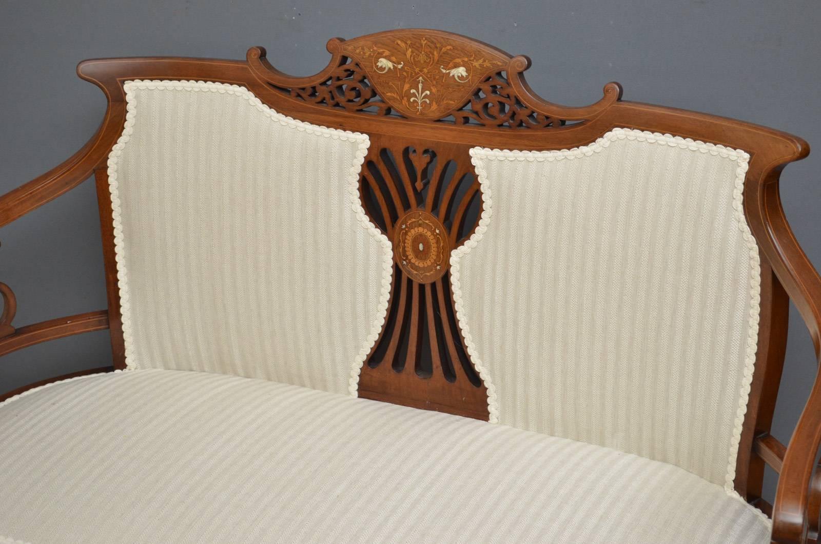 Sn4188 Edwardian mahogany and inlaid settee or couch, having finely inlaid top rail with fretwork and two upholstered panels, string inlaid open arms and shaped seat with string inlaid front rail, all standing on cabriole legs and pad feet. This