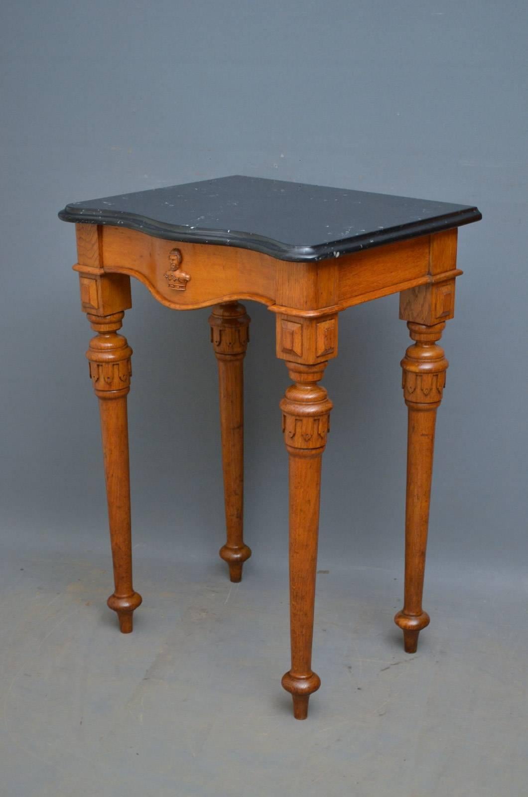 J00 Victorian, Gothic Revival oak hall table, having serpentine black veined marble top above frieze drawer, all standing on turned and carved tapered legs. This antique hall table is ready to place at home, circa 1870
Measures: H 36