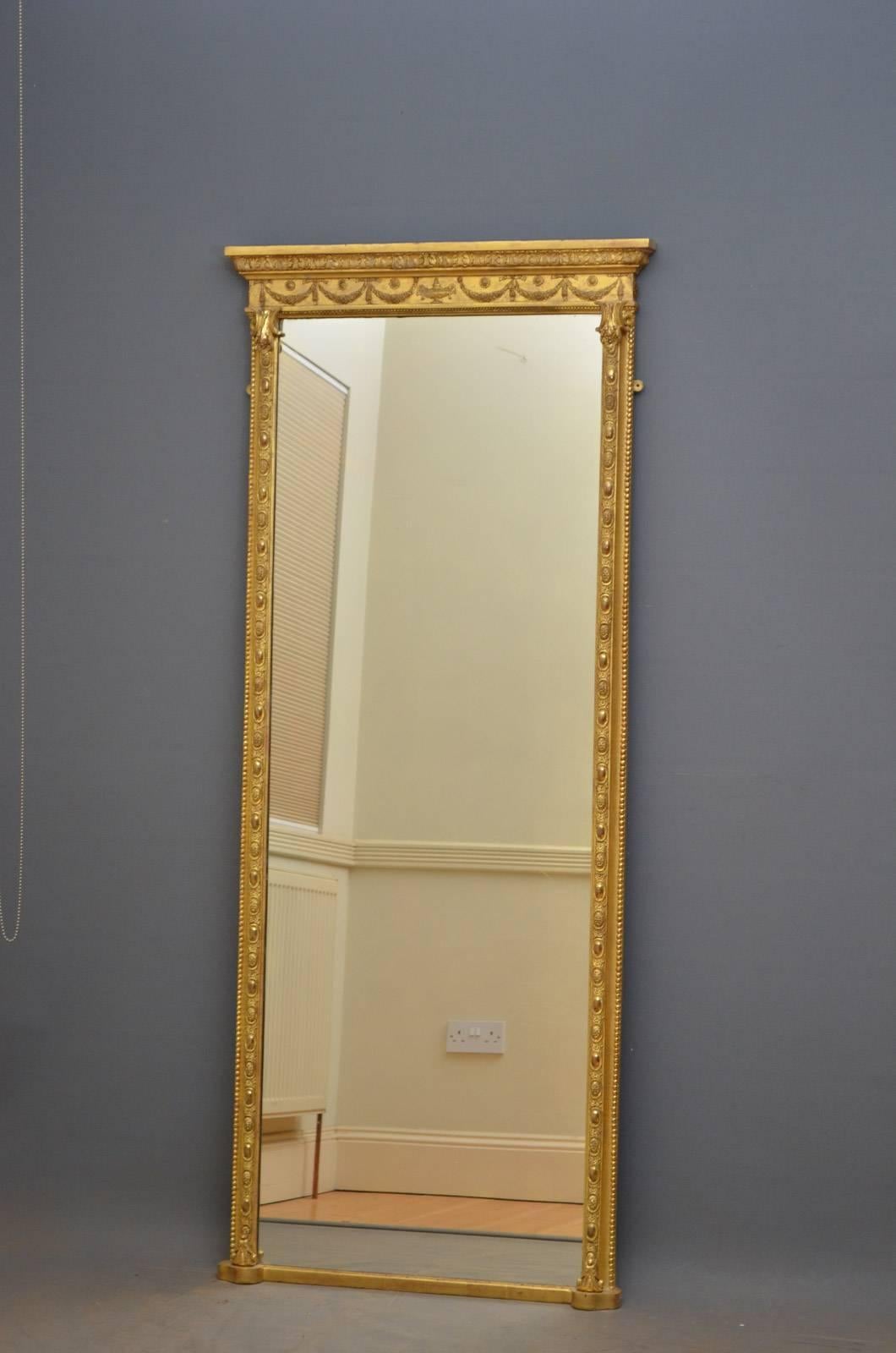 K0249 tall and slim early Victorian gilded mirror, having acanthus carved cornice above swags and bows and original mirror plate (with some imperfections) in finely decorated frame, all in excellent original condition throughout. This antique mirror