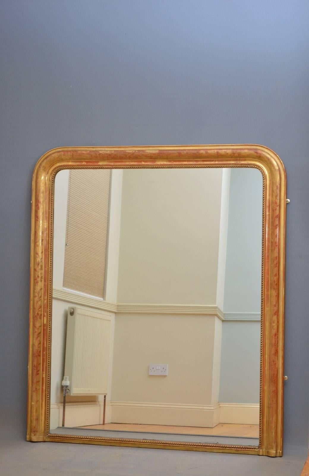 Sn4268 French giltwood overmantel mirror, having original mirror plate with some foxing in moulded frame decorated with flowers and leaves. This antique gilded mirror is in fantastic original condition throughout, ready to place at home, circa