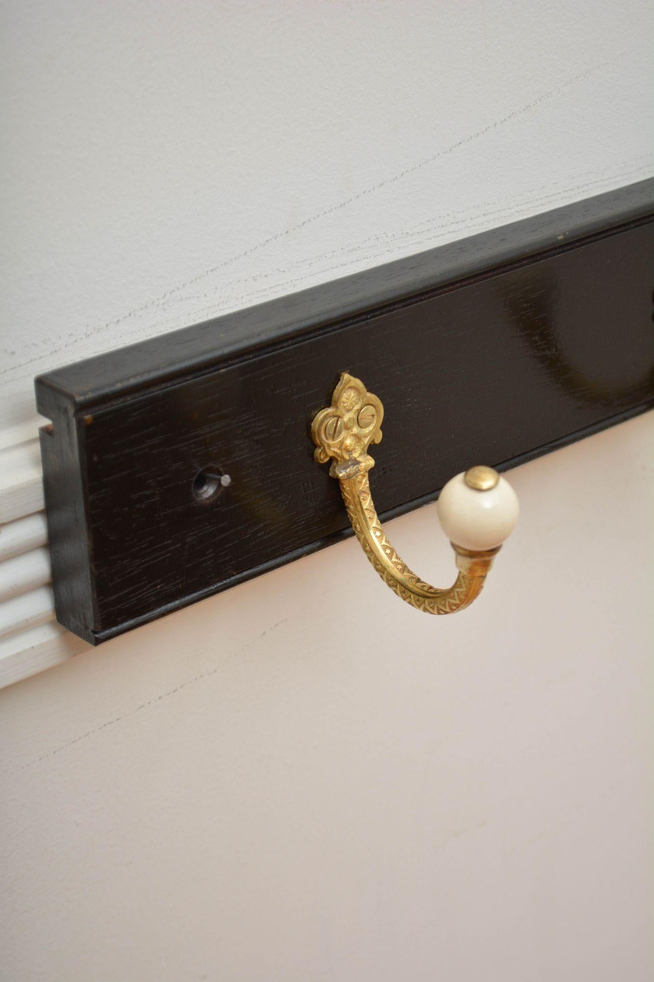 English Pair Of Ebonised Brass And Ceramic Coat Rack Coat Hooks For Sale