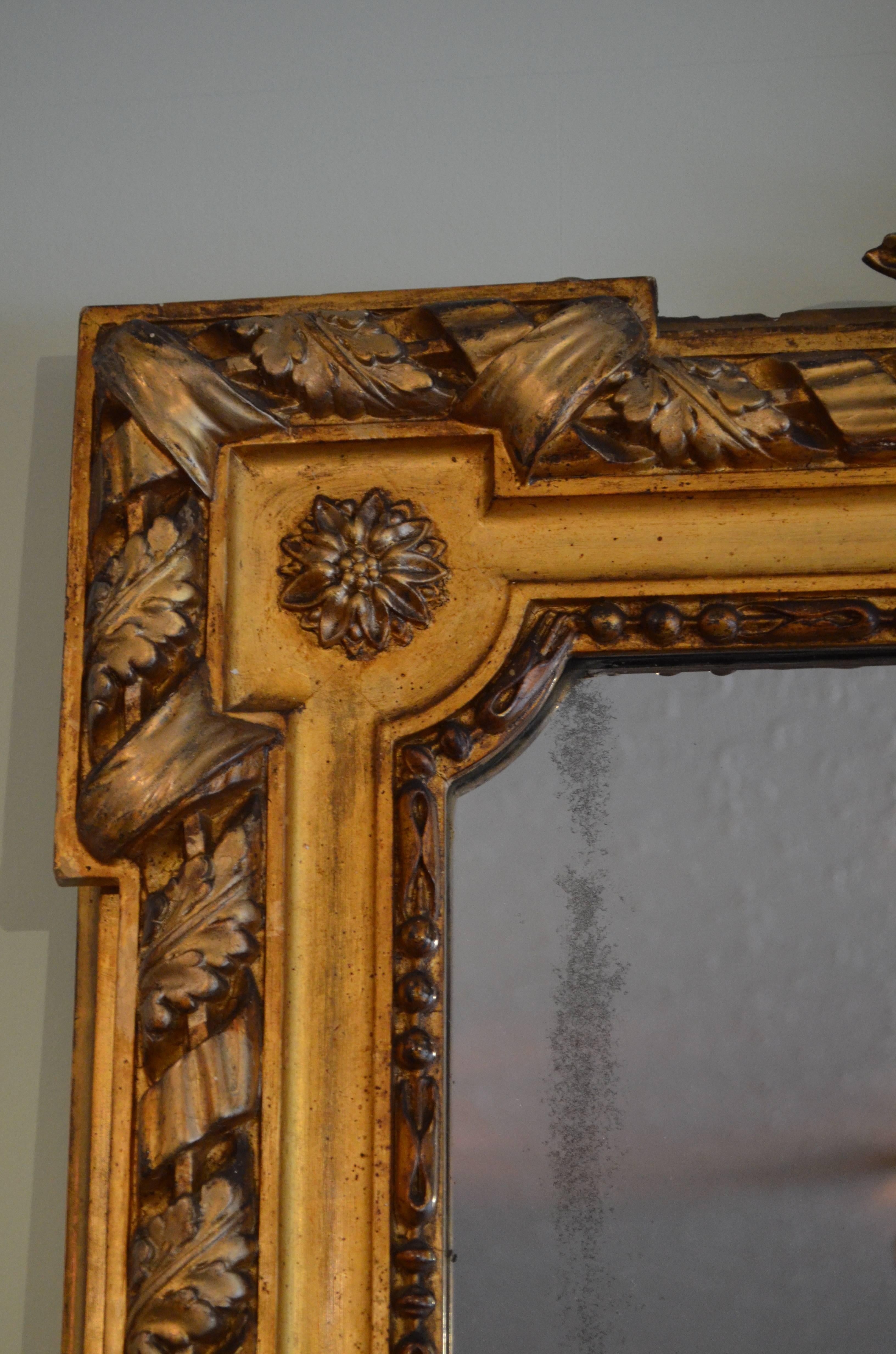 Sn4002 A striking 19th century gilt mirror, having foliage cresting to center and original mirror plate (with some silvering) in acanthus carved moulded frame.
This exceptional mirror retains original gilt, mirror plate and backboards, all in