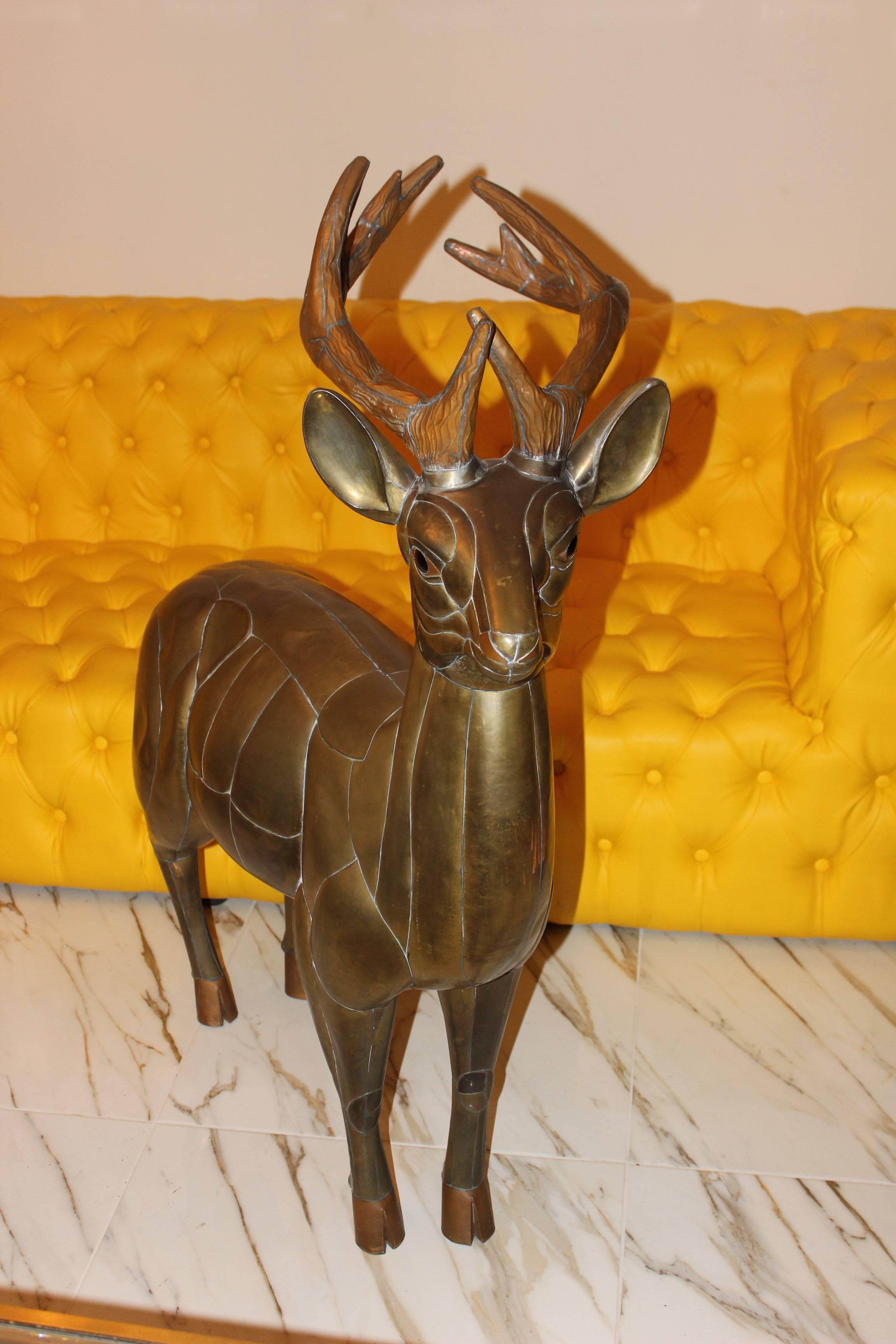 Sergio Bustamante deer sculpture signed 14 / 100. This beautiful copper deer is made by designer Sergio Bustamante and is signed with his signature! This item is very detailed by the parts of copper connected thru each other just look at the details