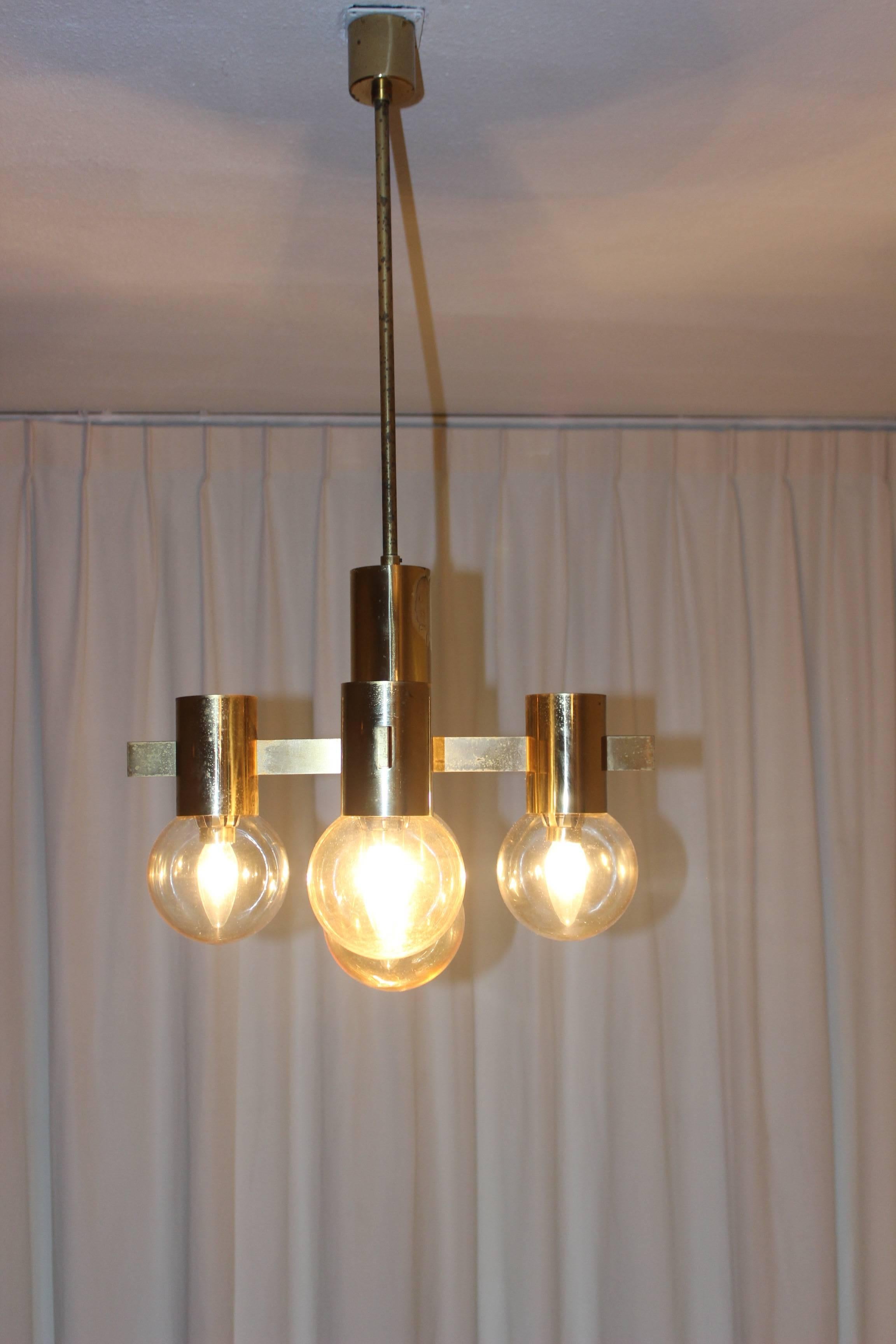 Gaetano Sciolari chandelier.

Rare beautiful brass chandelier with five smoked glass globes from the seventies, three chandeliers available in this line. If you are looking for a truly vintage look than these chandeliers are the way to go. Look at