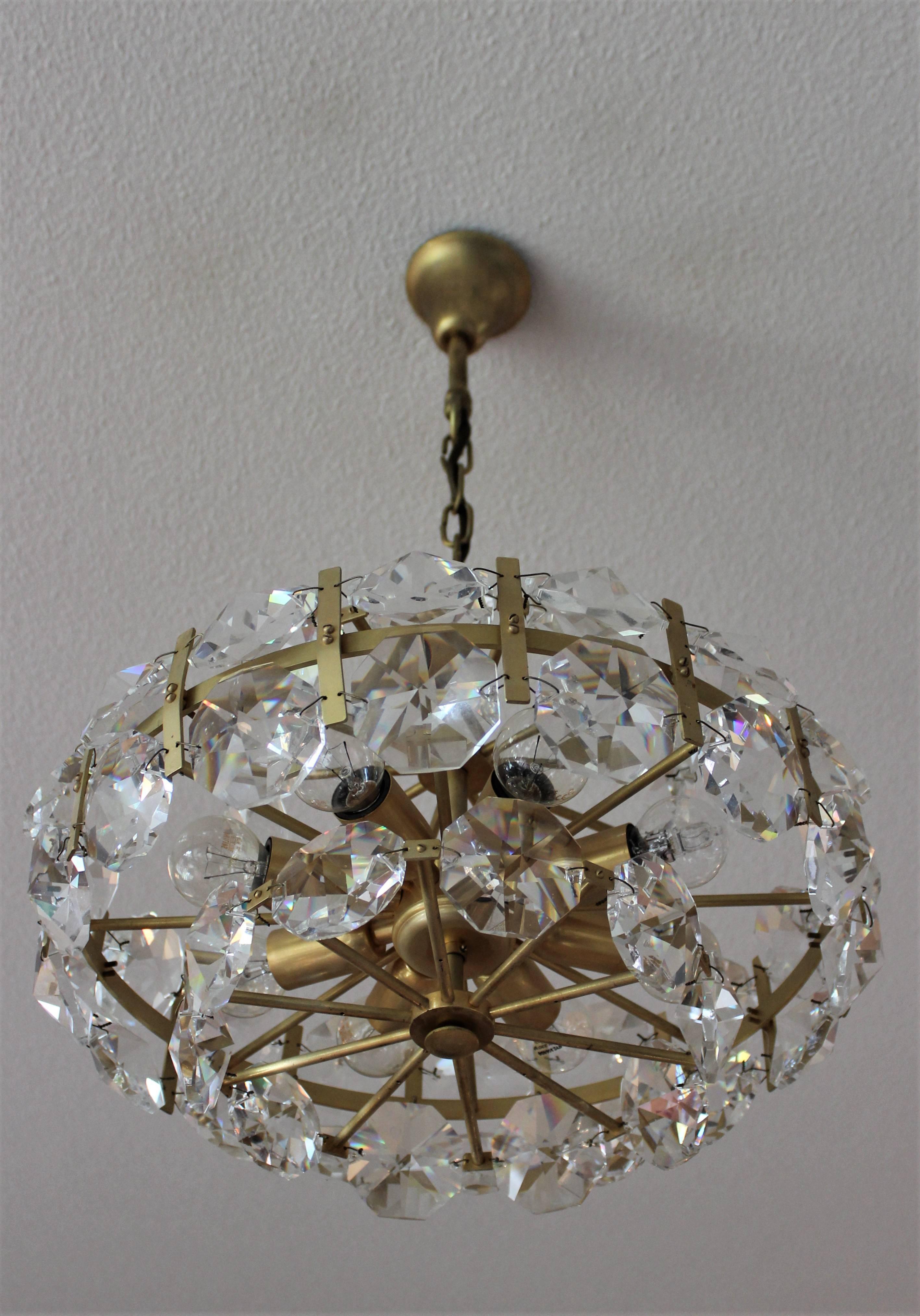 Another beautiful item for your home, interior

Beautiful gilt brass crystal chandelier, very large hand-cut crystals made in Austria, 1960s.
This Chandelier is more beautiful in real life and it comes with free shipping.
Comes with free bulbs
free