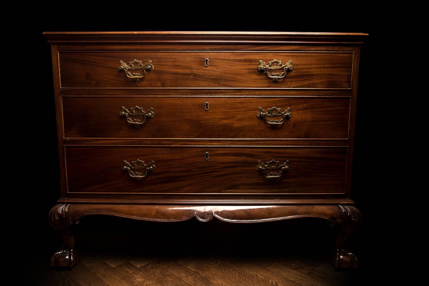 A quintessential King George II mahogany commode on later stand by M&M, stamped on top drawer and with ivorine label to stand. Of wonderful finish, classical good looks and proportions with typically English exuberant and substantial ball and