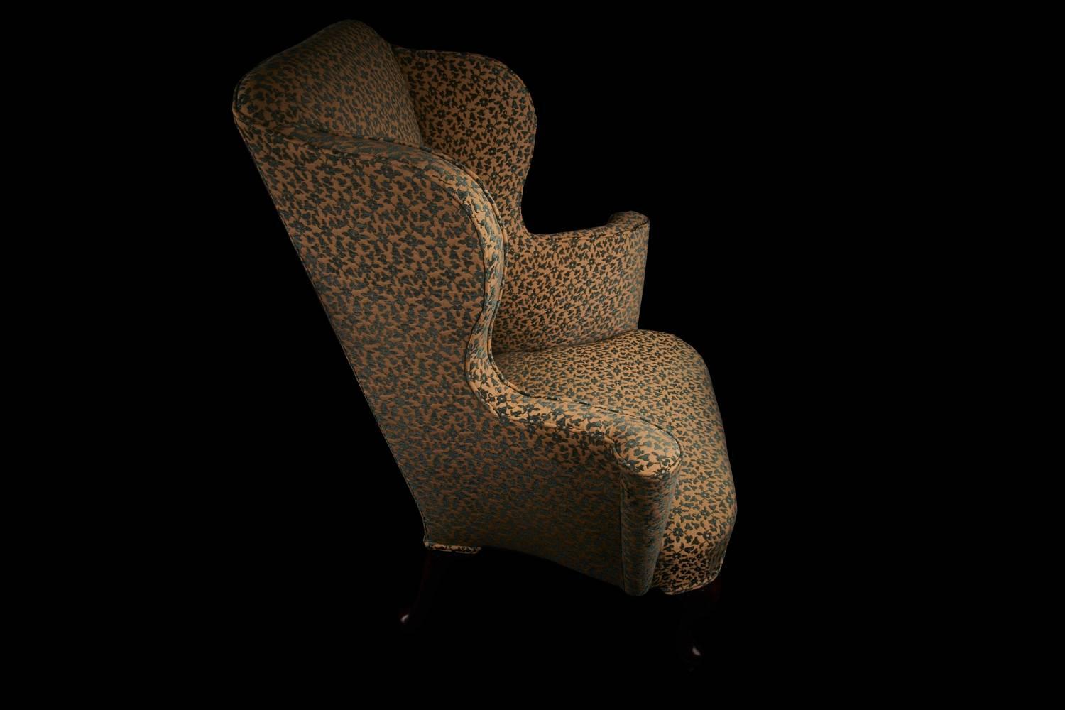 Wingback armchair with scrolling arms of beautiful and rare form. Featuring highly raised outwardly scrolling arms with cabriole legs on original castors. Newly upholstered in Pierre Frey Saphir jacquard, using highest quality materials and