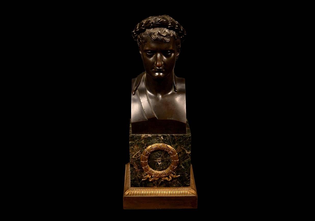 A fine piece. Napoleon as wears a laurel crown. Patinated bronze on green marble base with gilt bronze ormolu-mount and base.