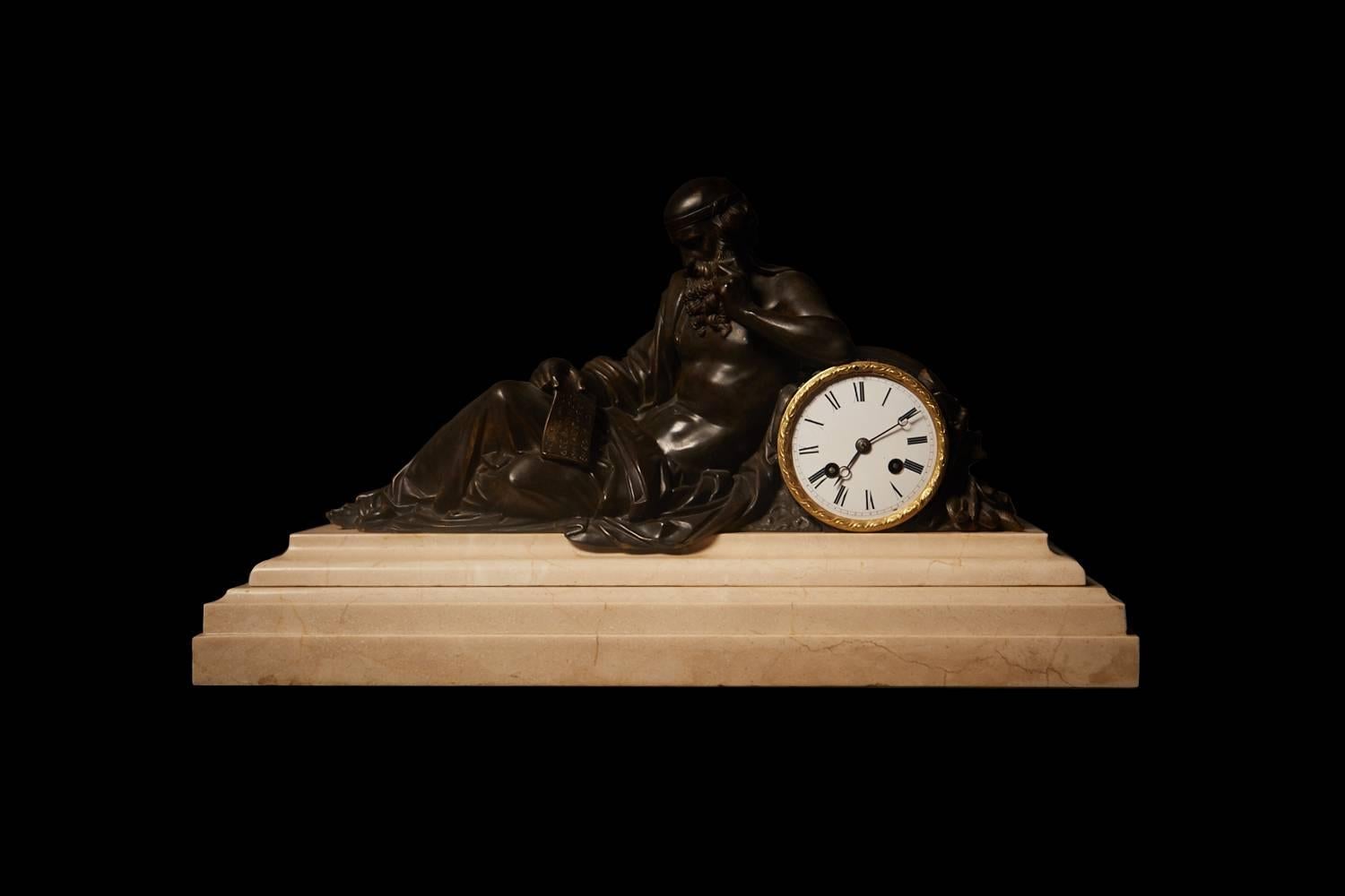A significant mantel clock, in the Louis XVI style. Bronze on a white marble stepped base.