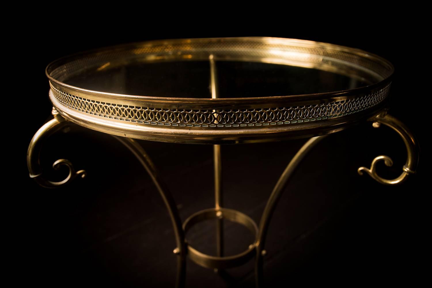 Timeless style. An iconic period 1930s bouillotte table, beautifully made - the round glass top with a circular pierced gallery, wonderful swept legs surmounted with a feature scroll and terminating in elegant swan's head feet,

France, circa