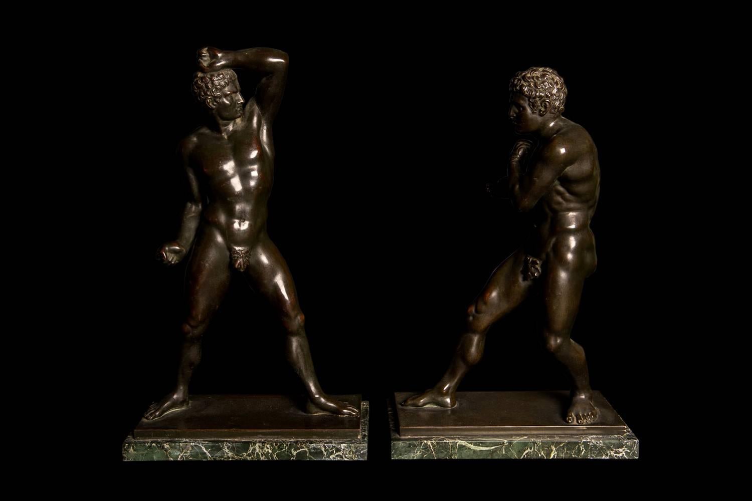 Stunning figures of substantial proportions and beautifully cast, these are the dramatic patinated bronze puglists Creugas and Damoxenos, after Canova. The originals can be seen in the Octagonal courtyard in the Vatican. Mounted on green marble
