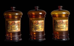 Three Balloon Lid Glass Apothecary Jars with Original Illustrative Labels