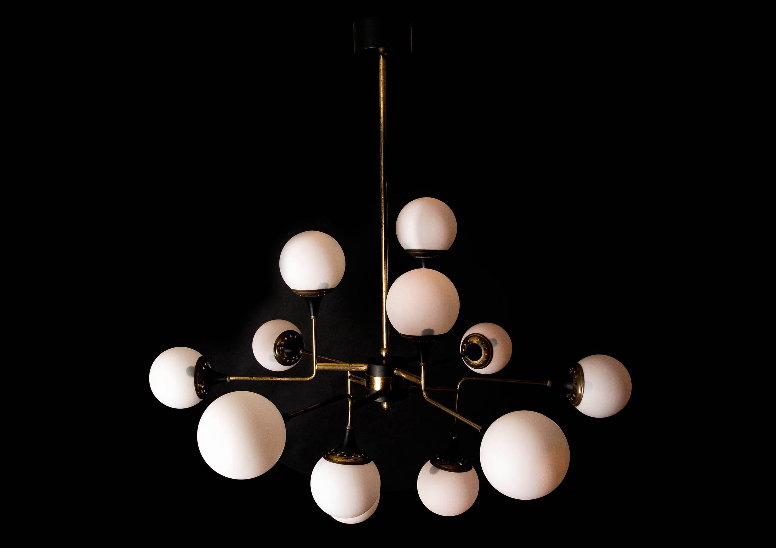 A timeless geometric design, iconic of the period and never bettered. Rare and original with superlative materials, stunning aged patina with 12 beautiful opaline satin glass balls (glass of this period has a quality all of it's own). Conceived and