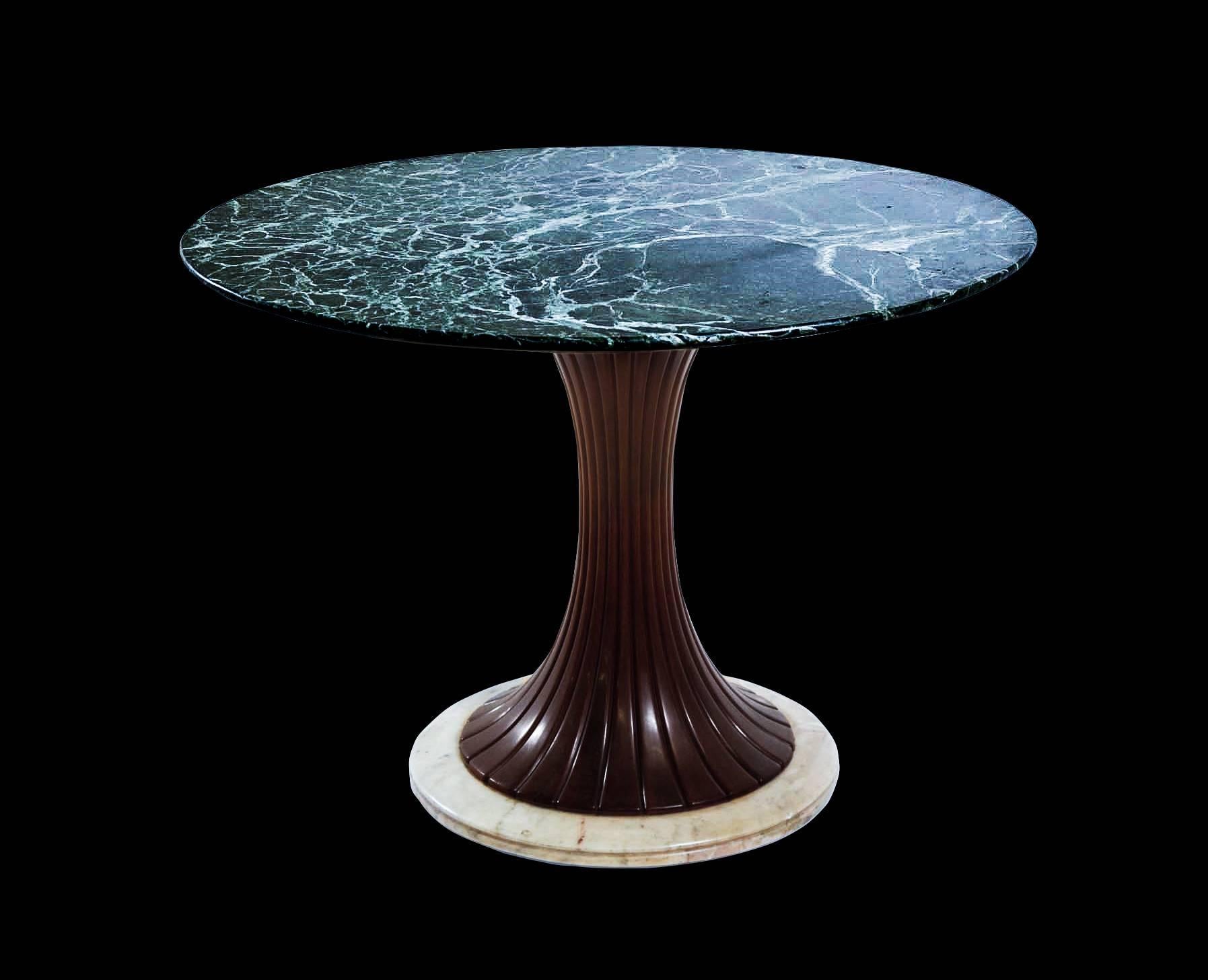 Iconic design by Dassi. Richly toned and variegated green marble top, fluted concave stem in walnut, terminating in natural marble base. 