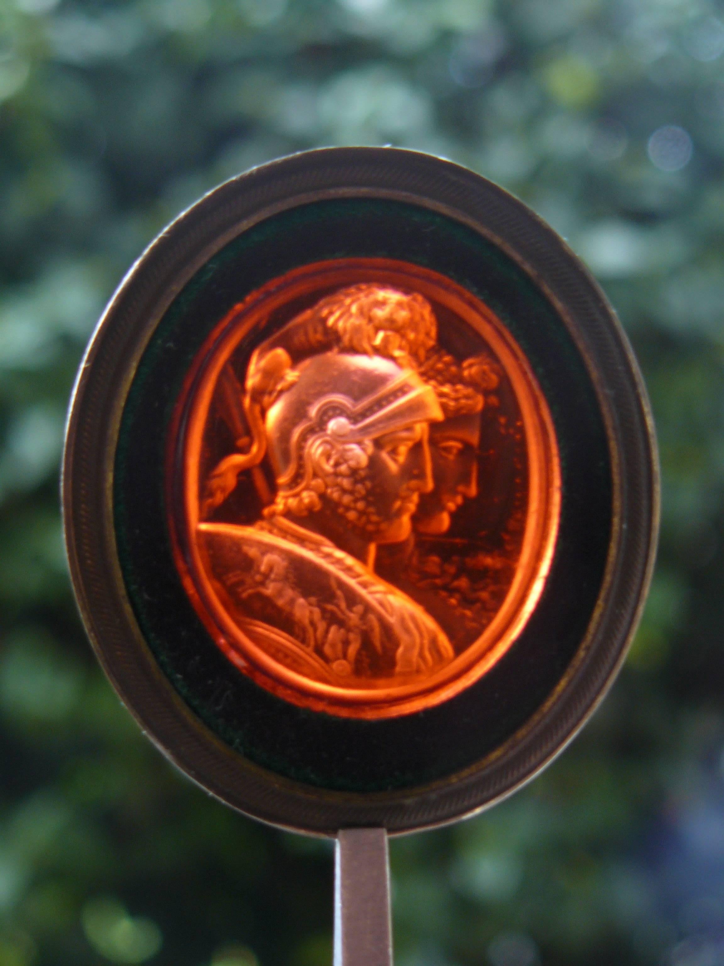 Mars and Bellona by Charles Brown (1749-1795).
Glass paste Intaglio with frame (brass and green velvet).
On the left the signature: C.BROWN INVT.
There is the same piece in light red cornelian in the state Hermitage Museum in SAINT PETERSBURG