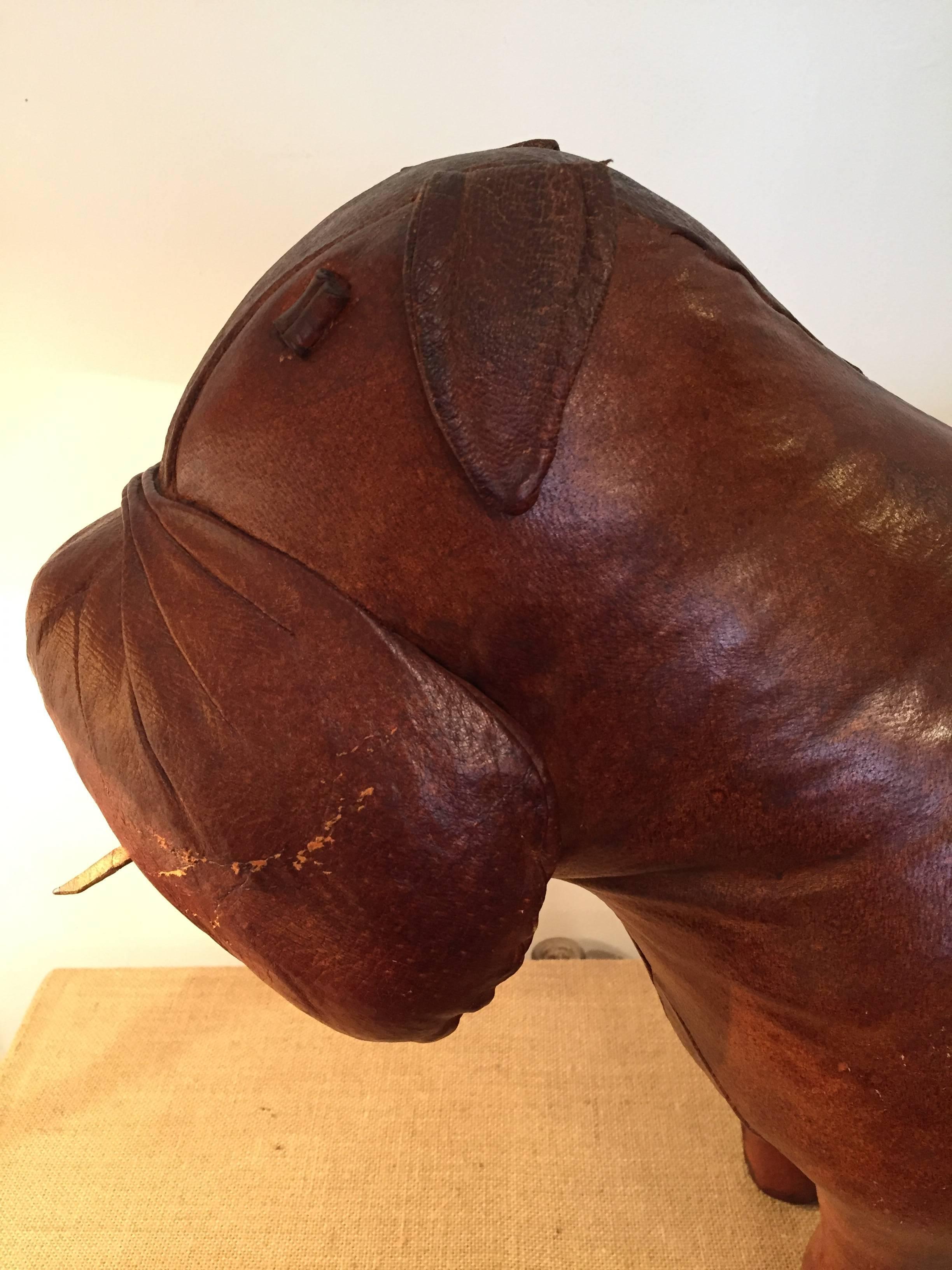 Vintage leather dog footstool by Dimitri Omersa for Abercrombie & Fitch.
It's seem to be like a bulldog.
   