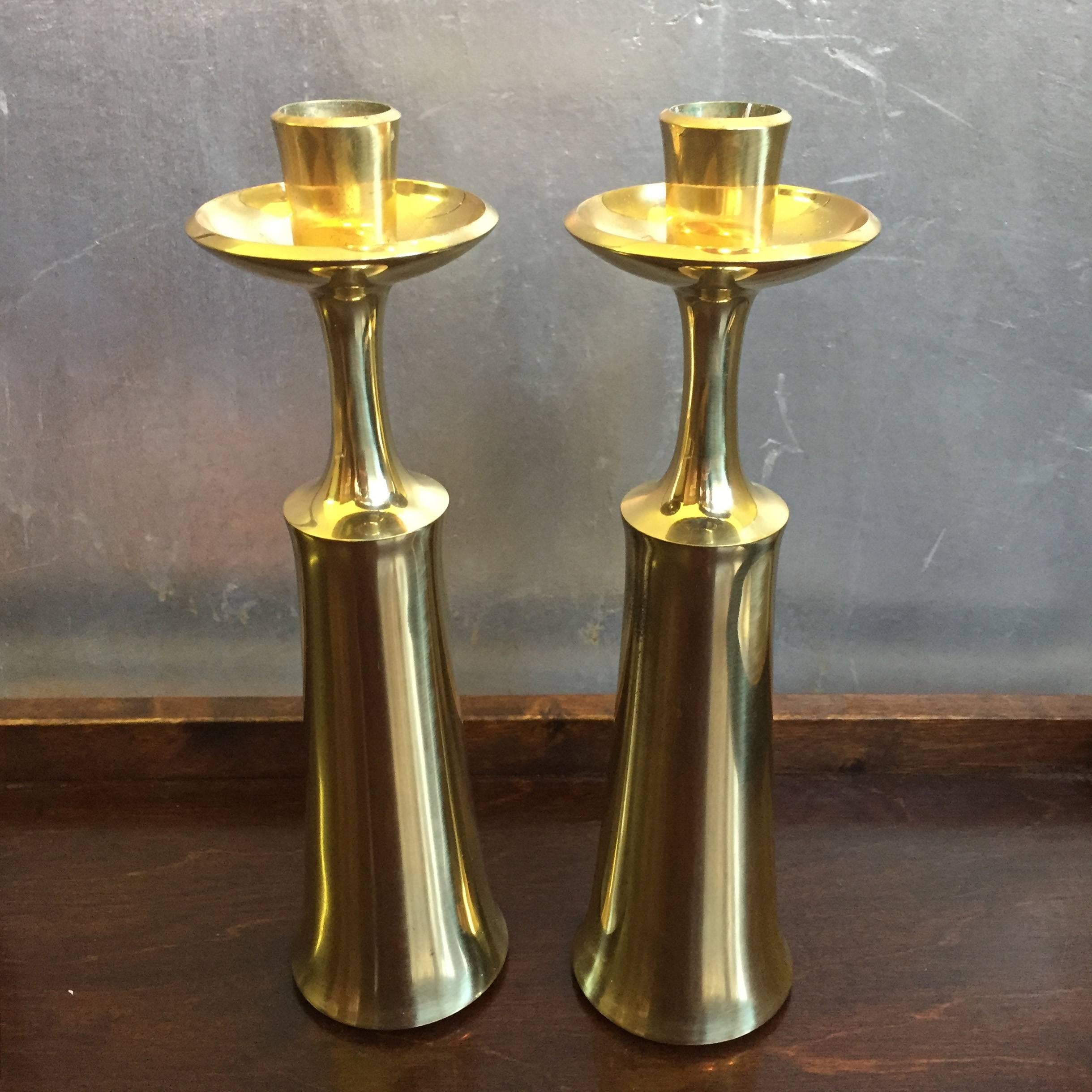 Two brass candleholders by the Danish designer Jens H. Quistgaard.