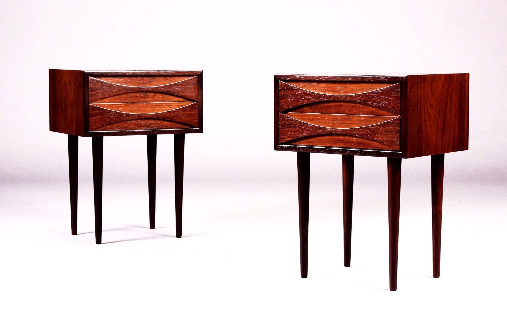 A pair of tall rosewood nightstands with slender legs and two drawers each. They are designed by Arne Vodder and are in excellent condition.

Arne Vodder is one of the most influential Scandinavian architects in the 20th century. His beautiful