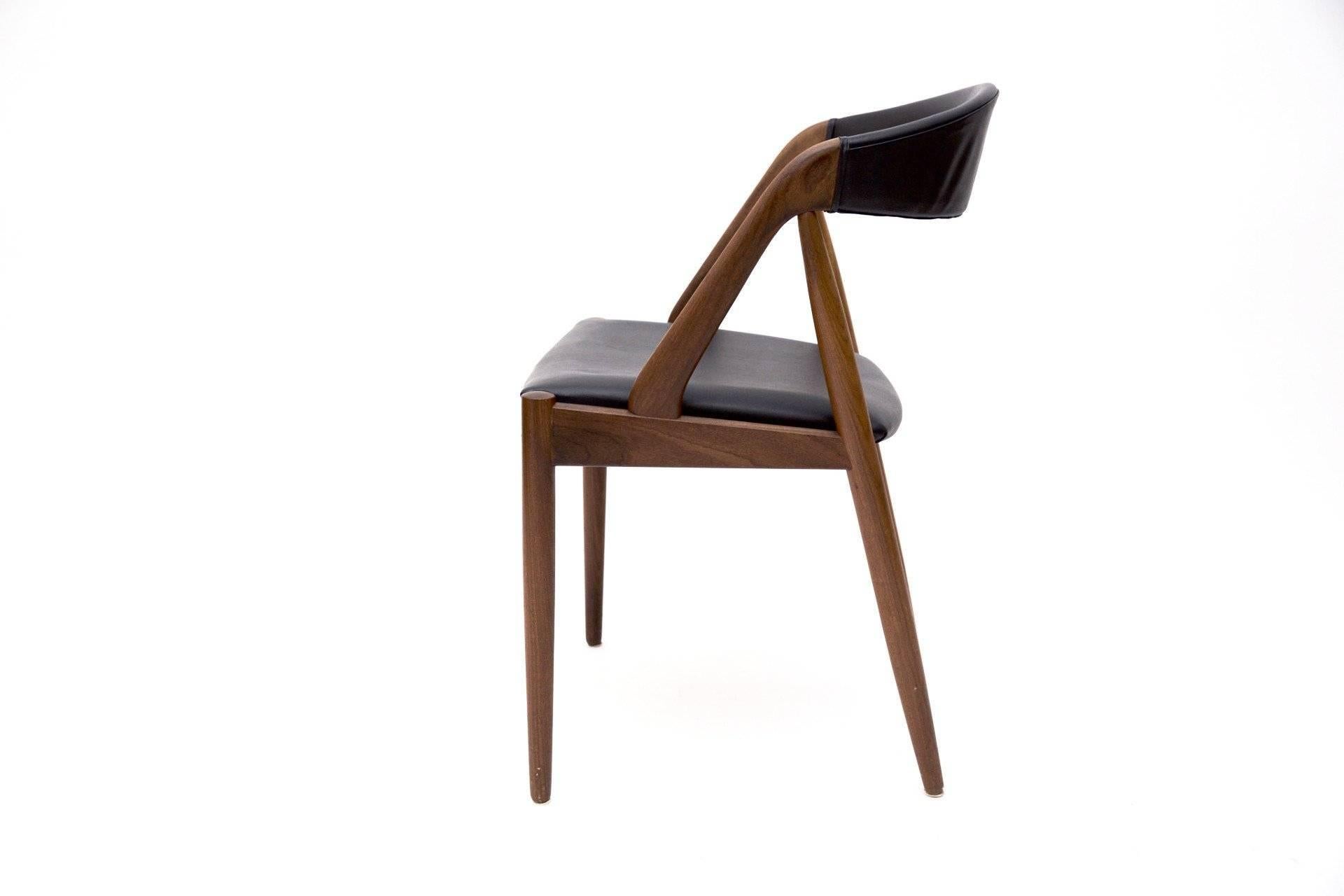 Four classic chairs by Kai Kristiansen. The unique model 31 is a beautiful chair with deep curved backrest that provides great comfort. The frame is made of a beautiful teak and the seat and backrest are covered in black skai. 

Kai Kristiansen