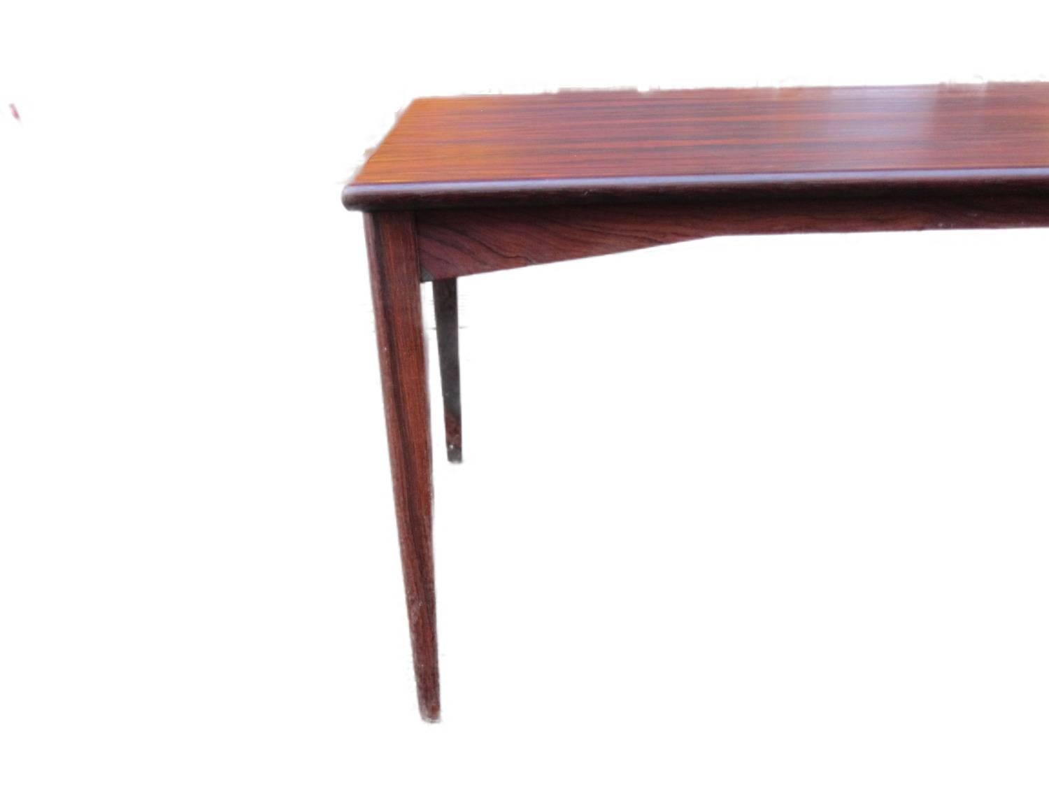 This Danish Mid-Century Modern sofa table is designed in Denmark. It has smooth angles and is more lightweight than similar tables in this category.

It comes in excellent vintage condition.