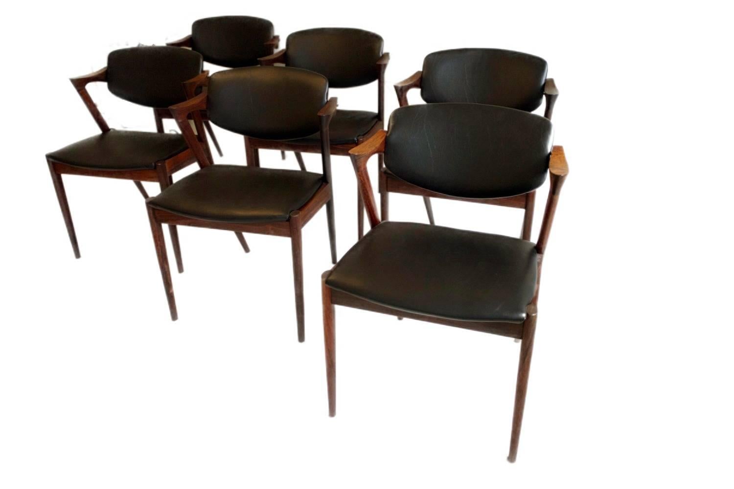 A set of six Kai Kristiansen, model 42, dining room chairs in rosewood. They come with black leather.

The chairs were designed in 1956-1957 and manufactured at Schou Andersen's furniture factory in Denmark.

We will ship worldwide. The buyer will