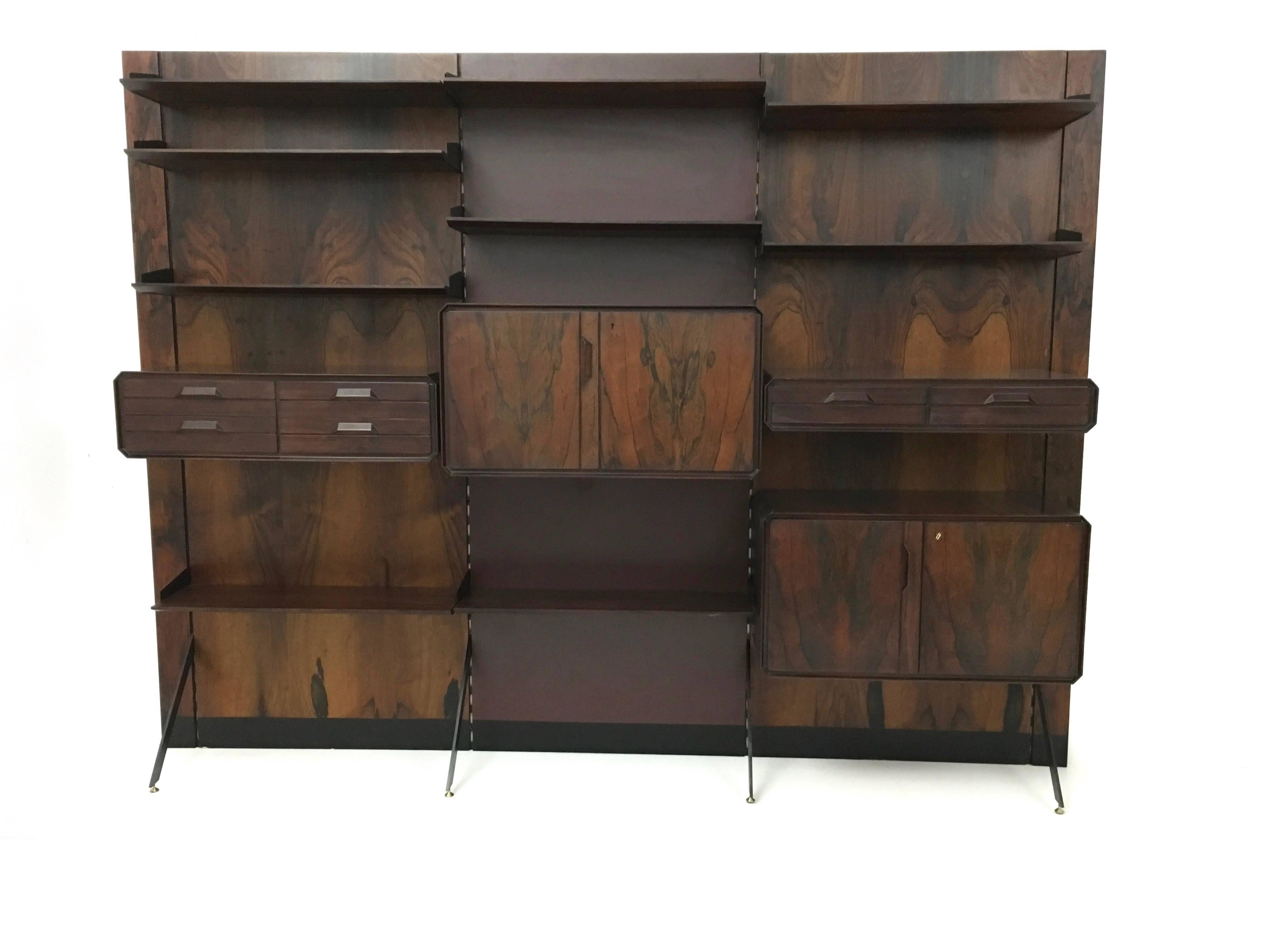 This 1960s bookcase is made from wood, formica, painted metal and features brass parts.
This fantastic piece is in excellent original condition with its original patina, and it is ready to become a piece in the home.
 
Width: 276 cm 
Depth: 45 cm