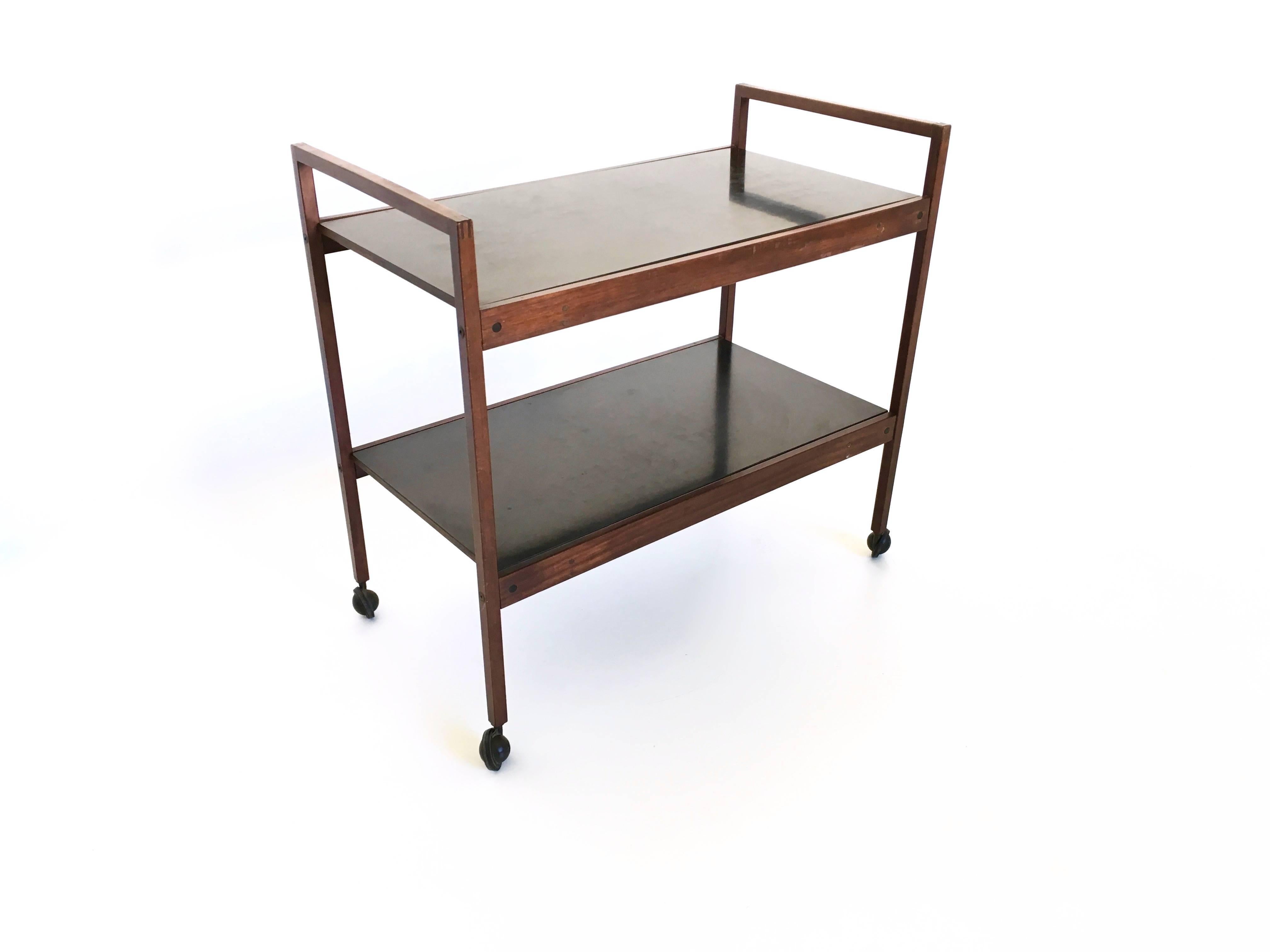 Serving cart made from mahogany and black formica.