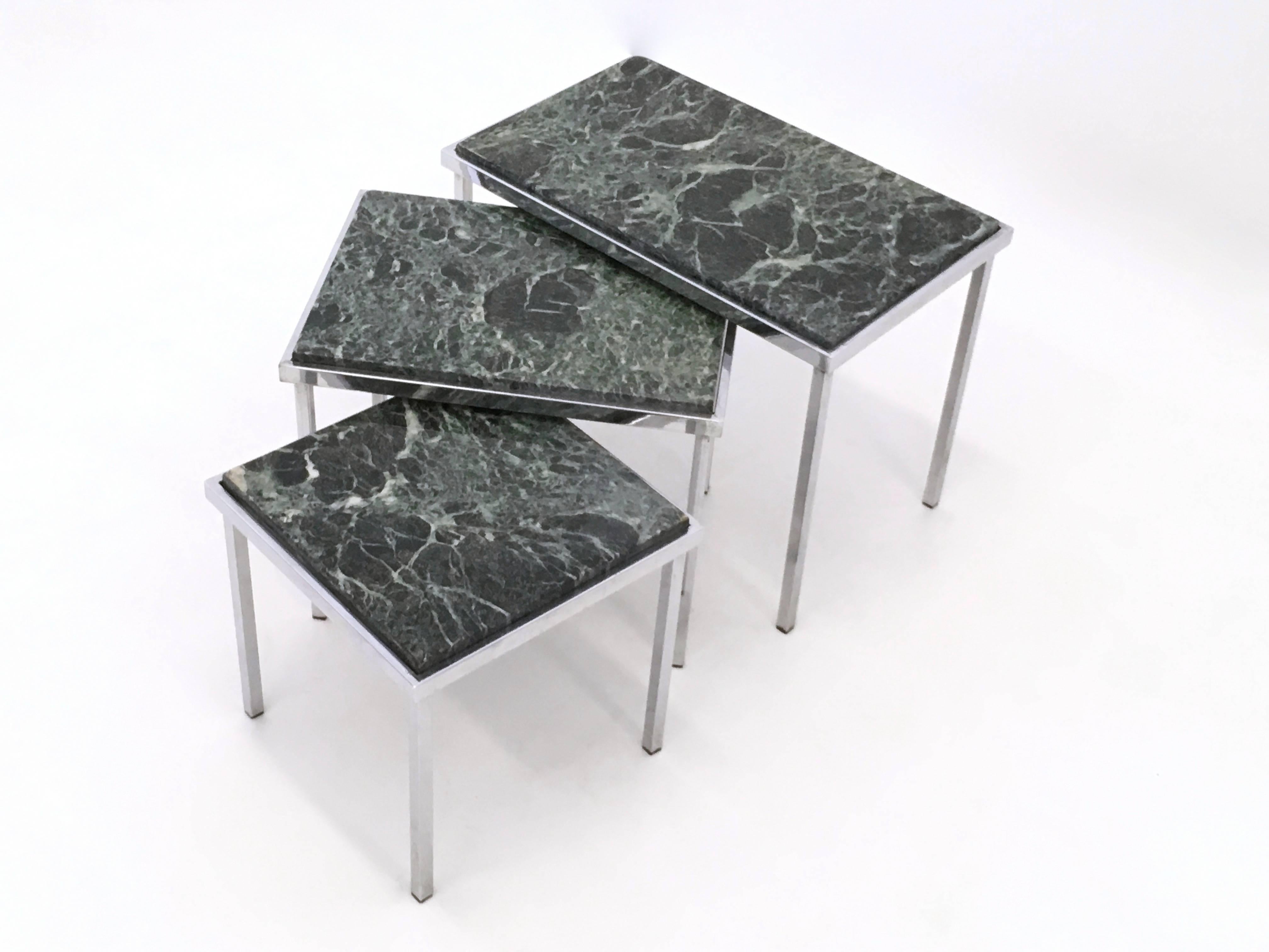 Set of three nesting tables made from chromed metal and green Alps marble. 
The measurements below refer to the largest one.
  