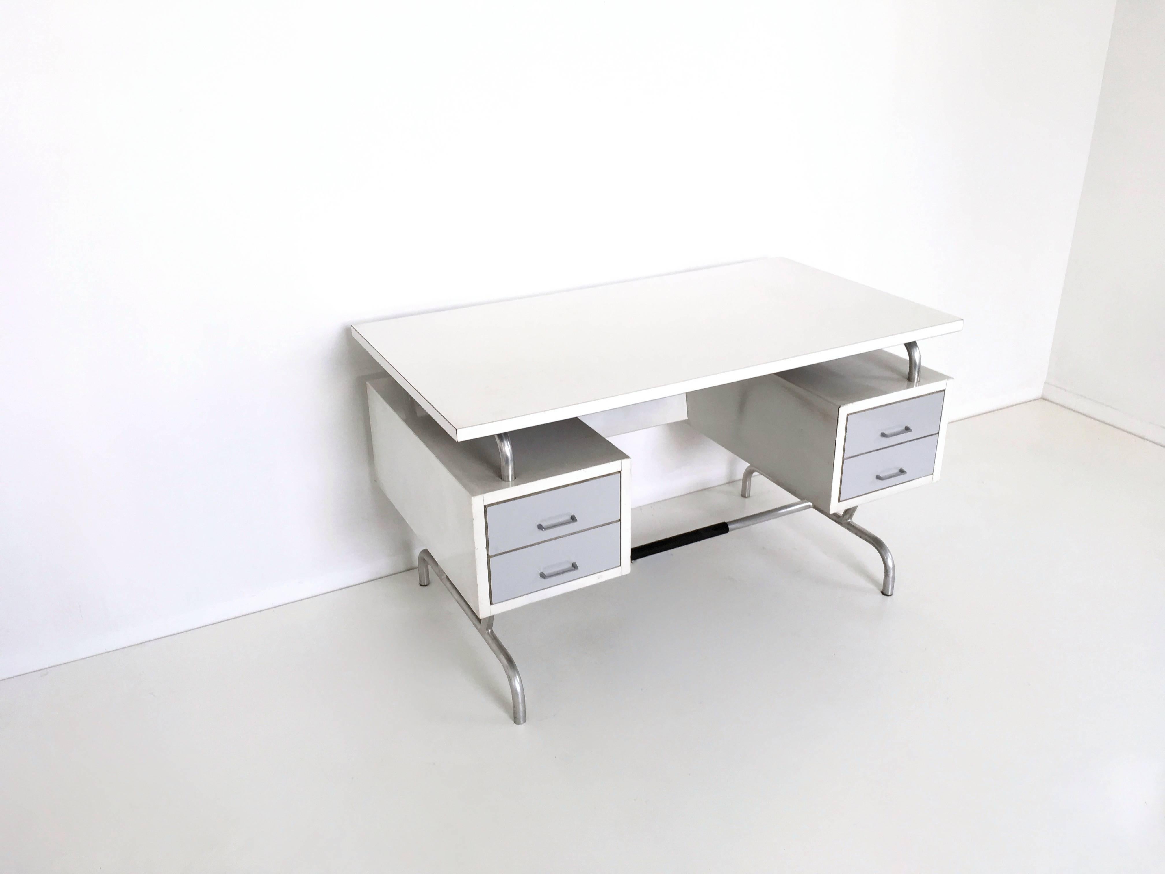 This desk is made from laminated wood, painted metal, aluminum and Formica.